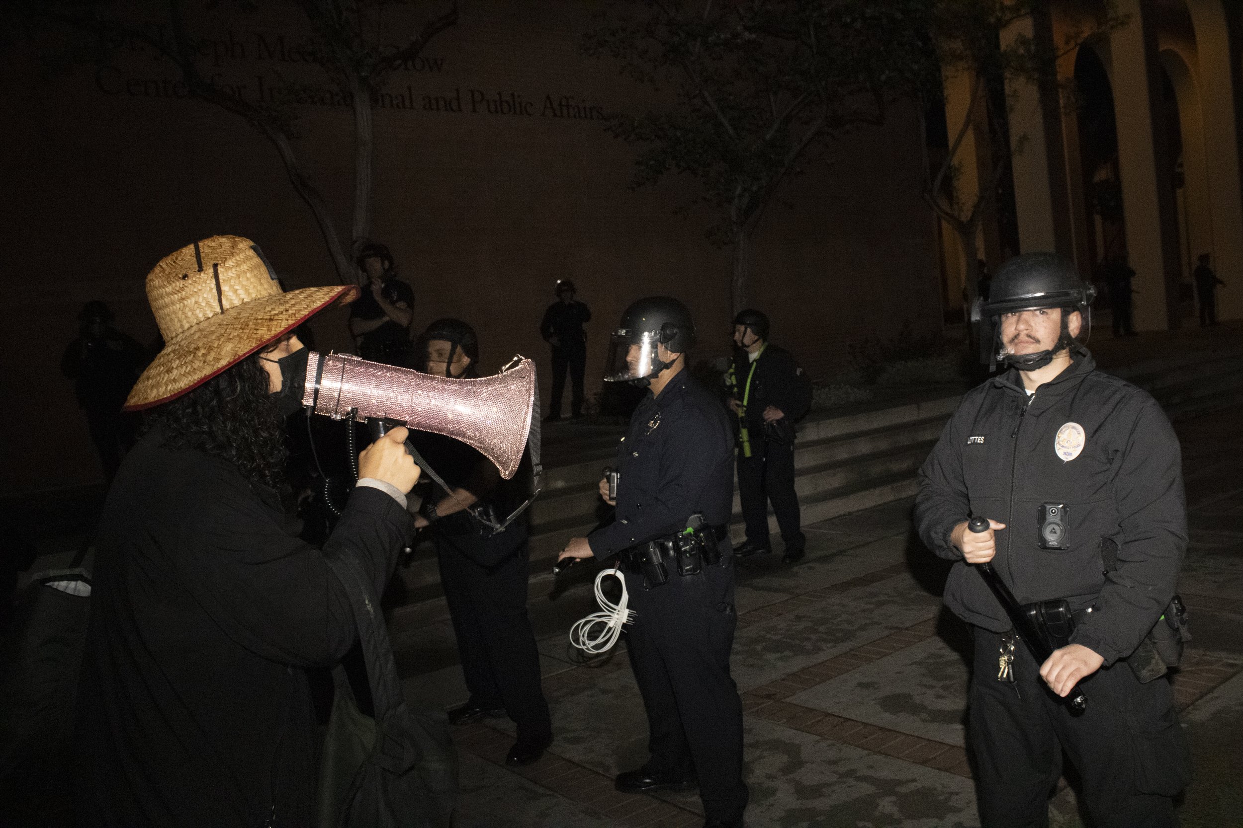  A protester from the University of Southern California Divest from Death coalition chants into his microphone “Disclose. Divest. We will not stop. We will not Rest,” in front of the University of Southern California Department of Security after bein