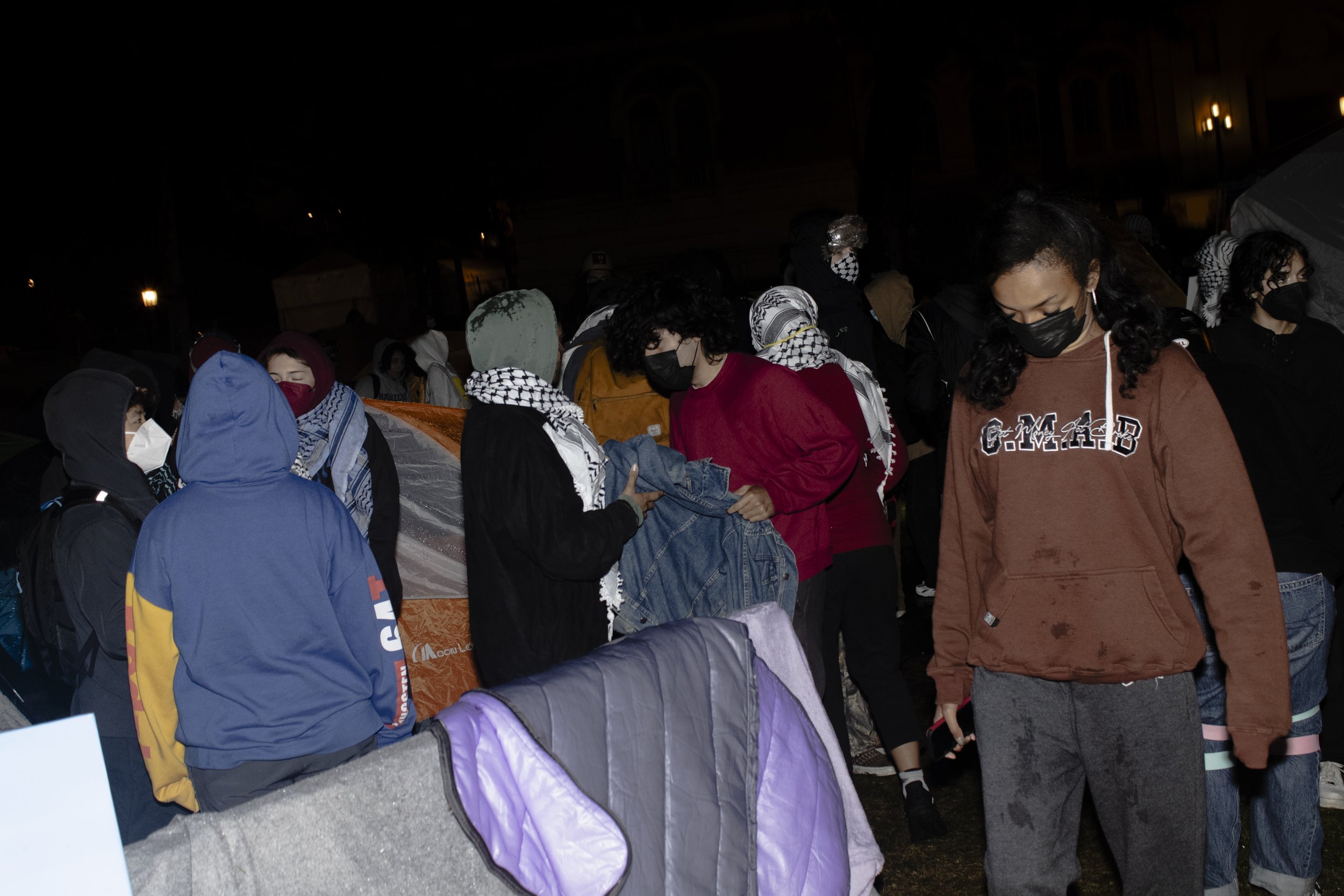  Protesters from the University of Southern California Divest from Death coalition emerge from their tent gathering supplies from their encampment after being told to disperse on Sunday, May 5, 2024, at The University of Southern California’s Alumni 