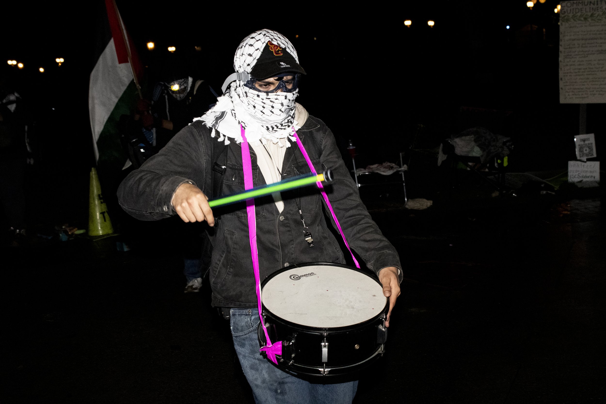  A protester from the University of Southern California Divest from Death coalition bangs their drum and marches after being told to disperse on Sunday, May 5, 2024, at The University of Southern California’s Alumni Park, in Los Angeles California. P