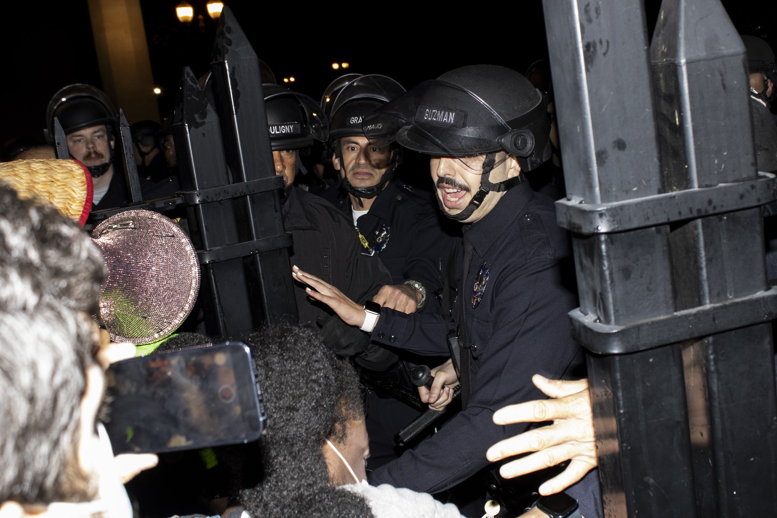  The University of Southern California Department of Security and Los Angeles Police Department officer close the Gavin Herbert Plaza gate on protesters at The University of Southern California, in Los Angeles California on Sunday, May 5, 2024, after