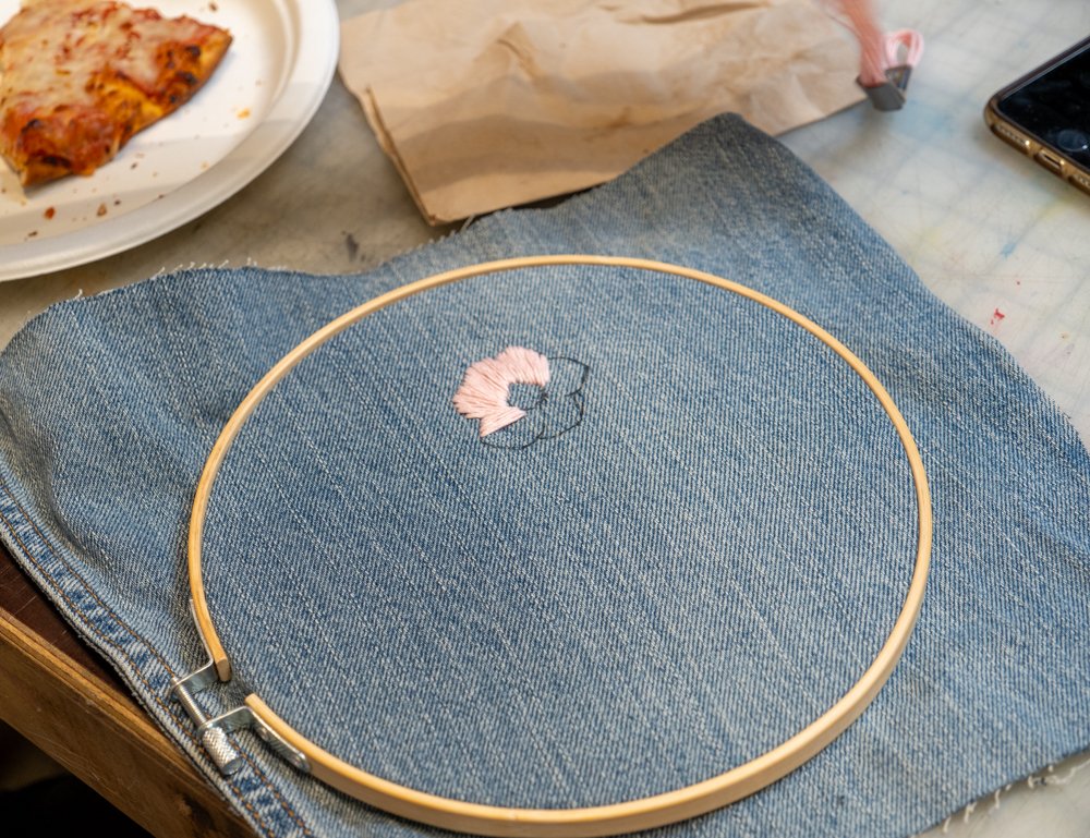  On National Denim Day a SMC student embroidered a small pink flower on a piece of denim. Denim Day was brought about when a controversial ruling was overturned in Italian Supreme Court in 1998. The decision cited that the victim must have participat