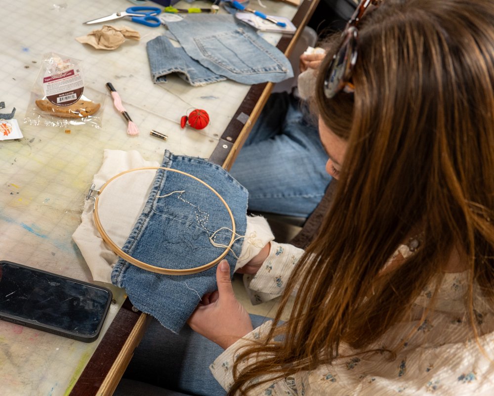  SMC Student is embroidering a horse for as her art piece on National Denim Day. Students and survivors were working harmoniously on their small projects during Sexual Assault Awareness Month as a way to "explore your inner voice" and find "healing s