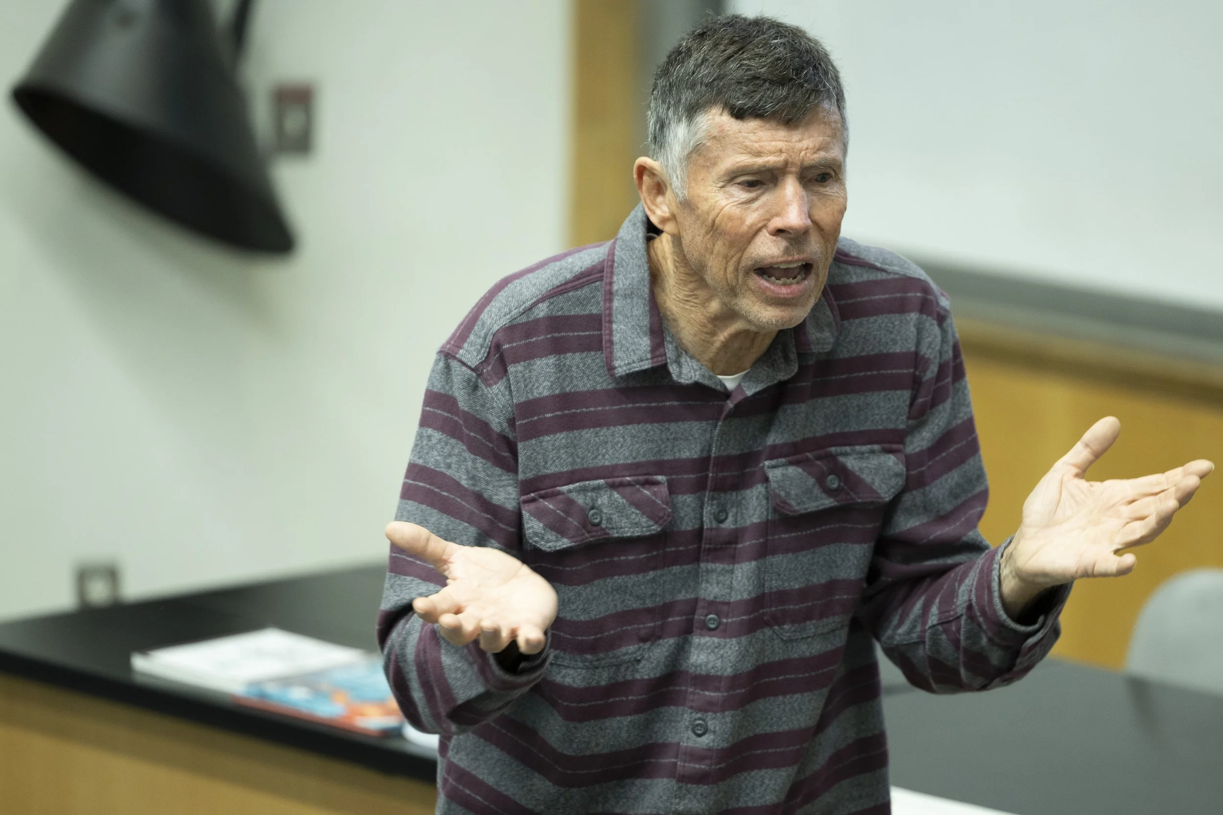  William Selby, a 71-year-old, retired Santa Monica College (SMC) geography professor and author of his latest book ‘The California’s Sky Watcher: Understanding Weather Patterns and What Comes Next’, gestures during his presentation as a featured spe