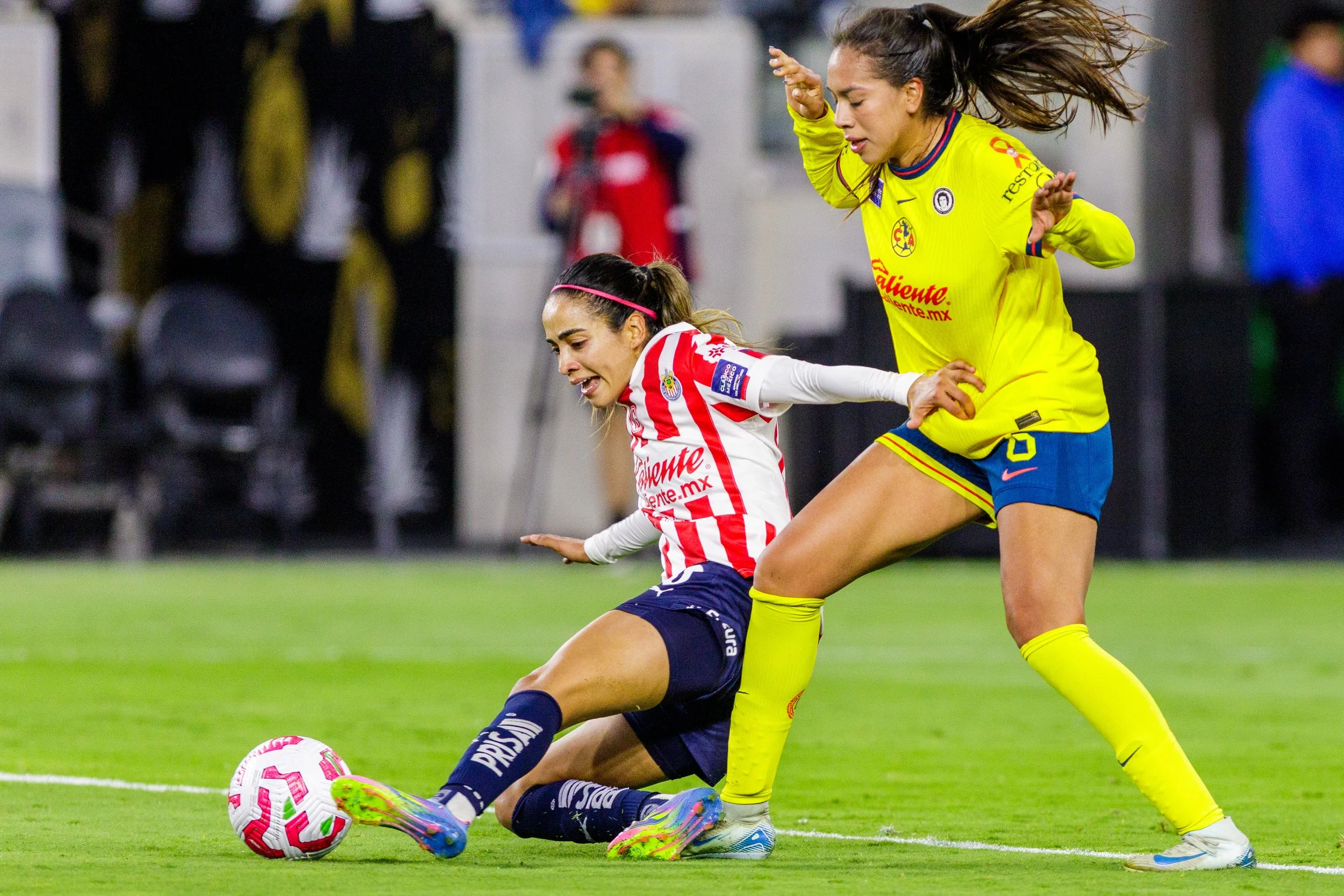 Carolina Jaramillo (Left), midfielder for Chivas de Guadalajara falls while trying to advance to forward, Noemi Granados, midfielder for Club América, defends and receives a yellow card for foul play on Saturday May 17, 2025 at Bank of Montreal (BMO