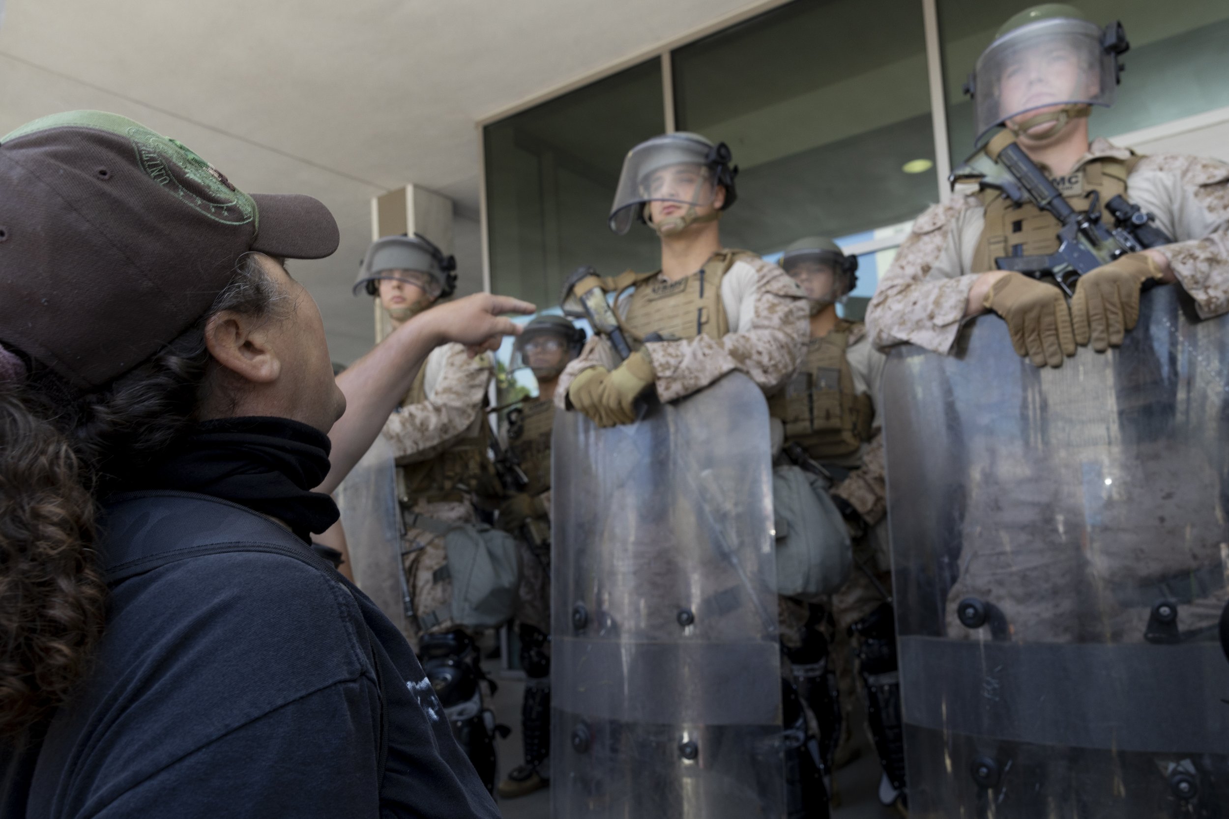 A protester yells at Marines guarding the Federal Building in Los Angeles, Calif., on Friday, July 4, 2025. 50501 SOCAL organized a protest called End The Occupation, criticizing the Trump administration’s passing of the Big Beautiful Bill and calli