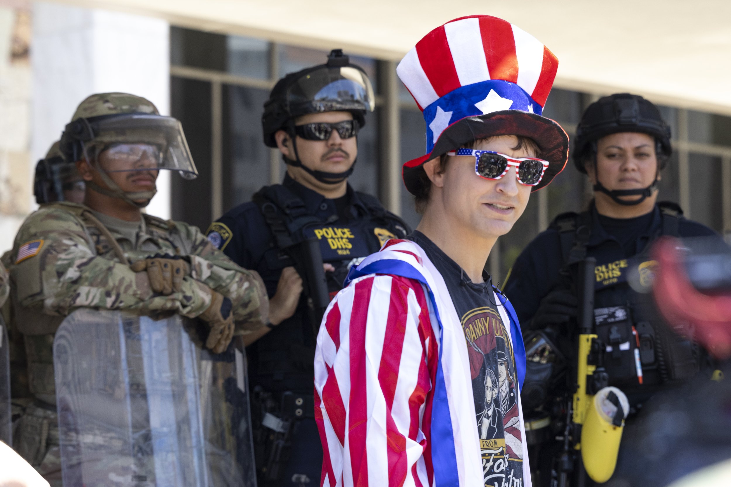 Danny Mullen, a conservative YouTuber stands in front of the Marines guarding the Federal Building in Los Angeles, Calif., on Friday, July 4, 2025. 50501 SOCAL organized a protest called End The Occupation, criticizing the Trump administration’s pas