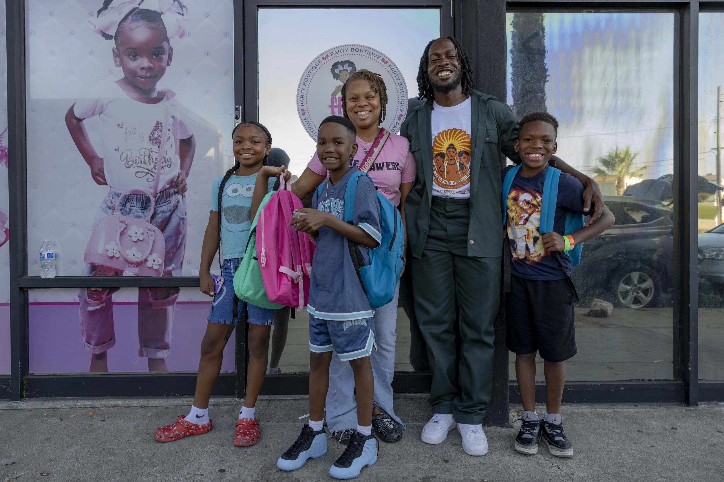 Aliyah Hudspith (Left), a mother experiencing financial hardship after having surgery, and Justin Ellis-Brooks (Right), an SMC student and founder of Umoja Now, posing for a photo with Aliyah’s family on East Manchester Boulevard in front of Event S