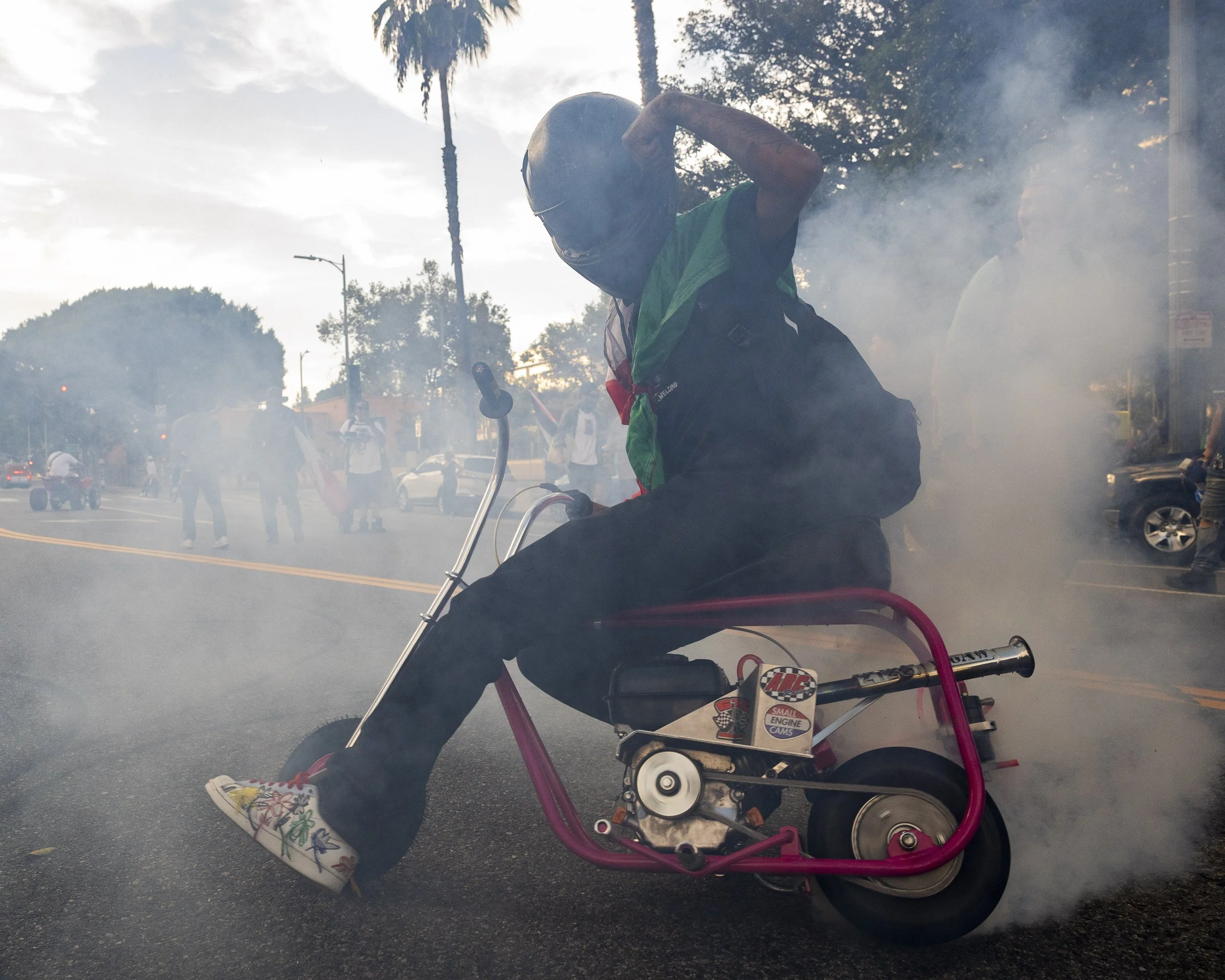 A minibiker performed a donut in front of the Los Angeles Police Department Headquarters on West First Street in Los Angeles, Calif., on Monday, Sept. 1, 2025, during a protest held on Labor Day organized by the activist group, ICE out of LA. ( Kayj