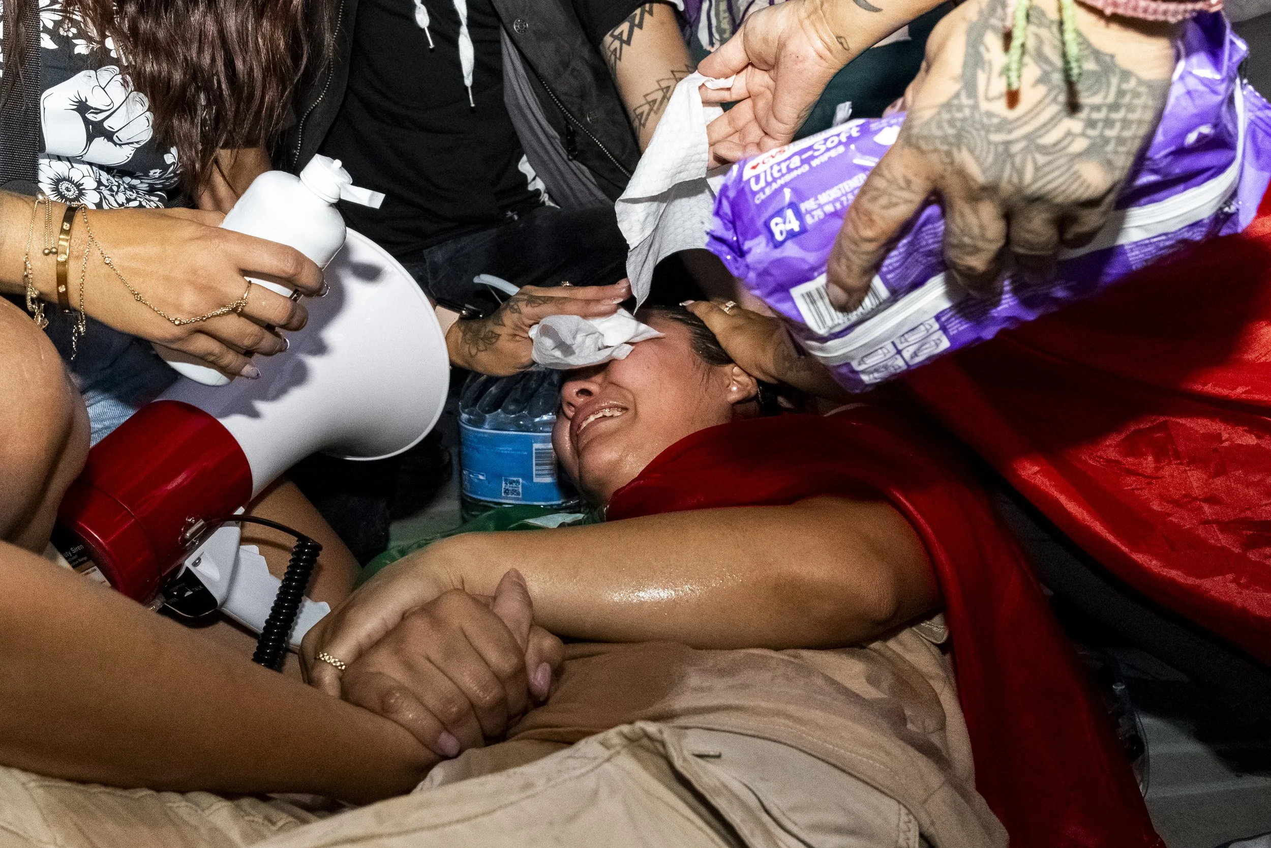 A protester had her eyes flushed across the street from the Metropolitan Detention Center in Los Angeles, Calif., on Monday, Sept. 1, 2025, during an anti-ICE protest after being pepper-sprayed by Department of Homeland Security federal agents. (Kay
