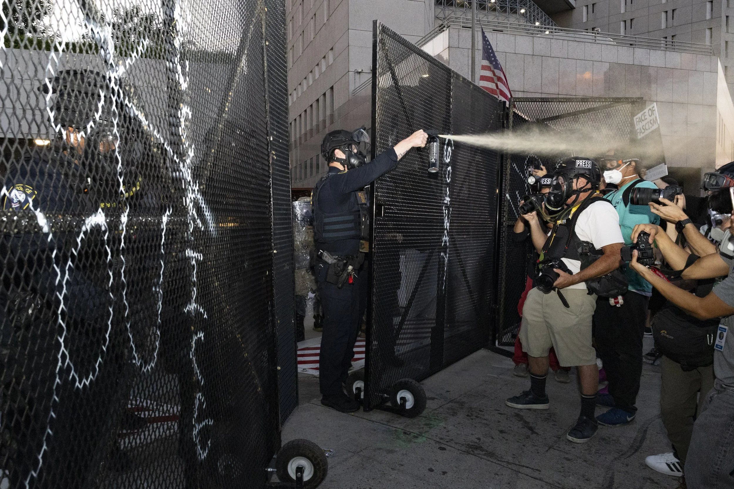 A Department of Homeland Security federal agent fired pepper-spray at the crowd in front of the Metropolitan Detention Center in Los Angeles, Calif., on Monday, Sept. 1, 2025, during an anti-ICE protest, striking multiple journalists. (Kayjel J. Ma