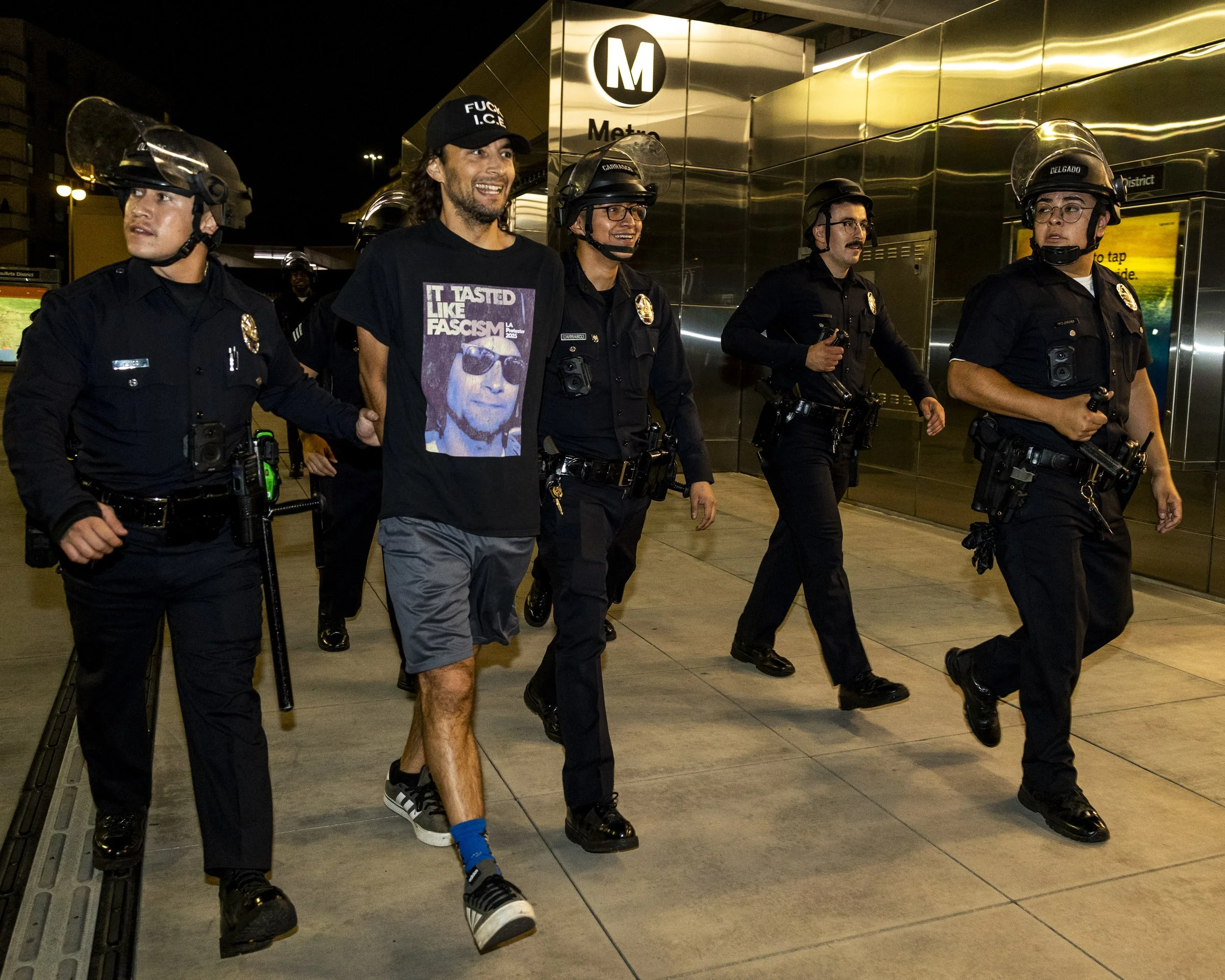 A protester smiled and laughed as the Los Angeles Police Department arrested him on north Alameda and east Temple Street in Los Angeles, Calif., on Monday, Sept. 1, 2025, after an anti-ICE protest at the Metropolitan Detention Center. (Kayjel J. Mai
