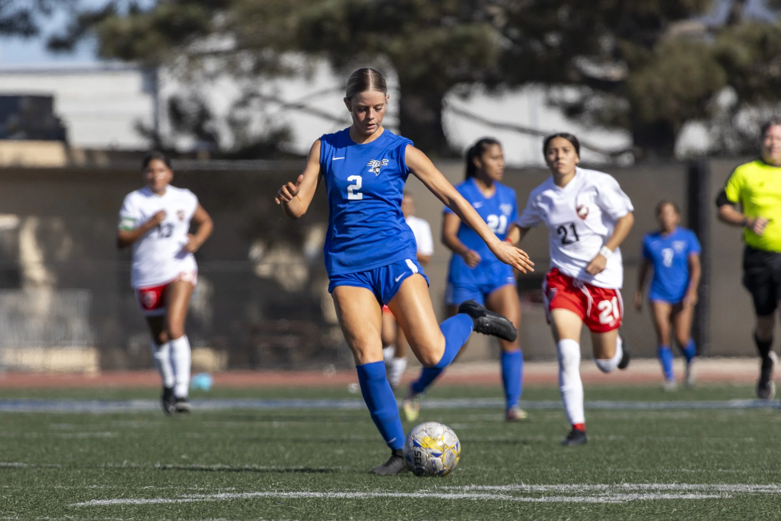 Forward Jocelyn Coronado (#21) of the Pierce College Brahmas, with Brahmas defender Stephany Ramirez (#17) in tow, takes a fall after being pursued by Santa Monica College Corsairs defender Adriana Maldonado (#21), on Tuesday, September 9, 2025, at