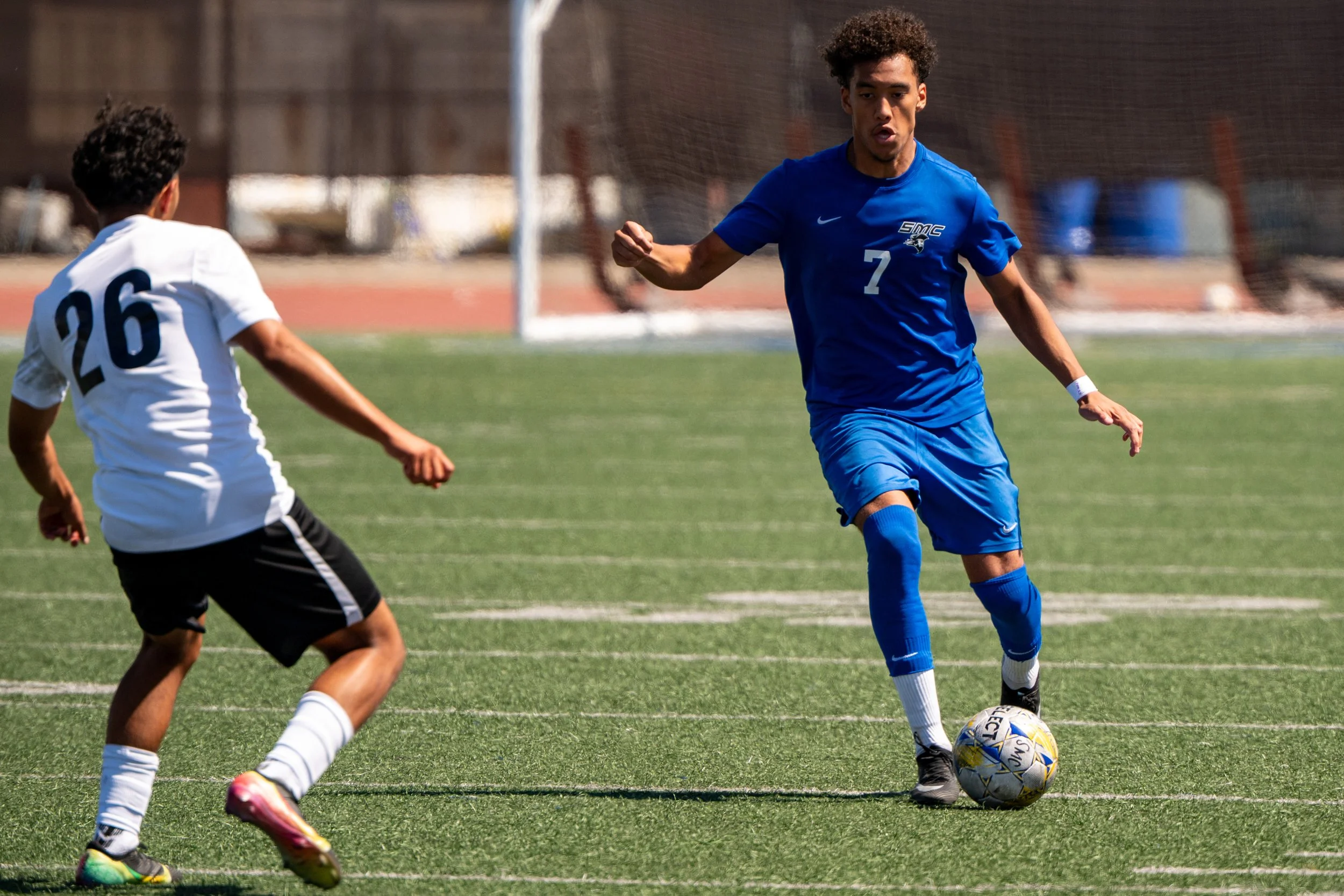 Santa Monica College (SMC) Corsair midfielder (7) Lyric Gomez-Muniz moving the ball passed Fullerton College Hornet (26) Michael Espinoza on Tuesday, September 9, 2025, in Santa Monica,Calif. The Corsairs tide with the Hornets 4-4.(Tom Rosholt | Th