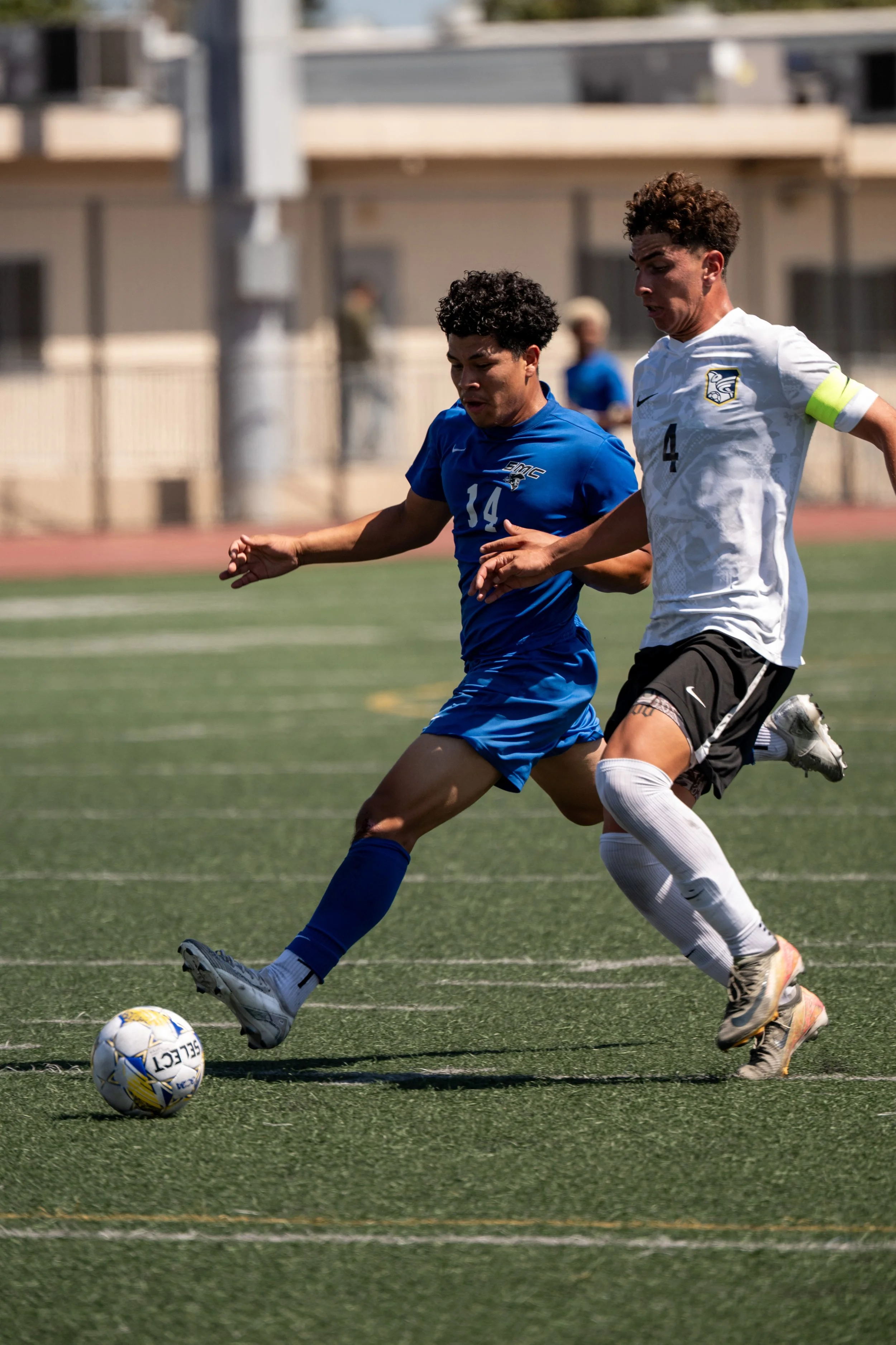 Santa Monica College (SMC) Corsair defender (14) Maeva Dubuque drives the ball past Fullerton College Hornet (4) Andrew Arreola on Tuesday, September 9, 2025, in Santa Monica,Calif. The Corsairs tide with the Hornets 4-4.(Tom Rosholt | The Corsair)