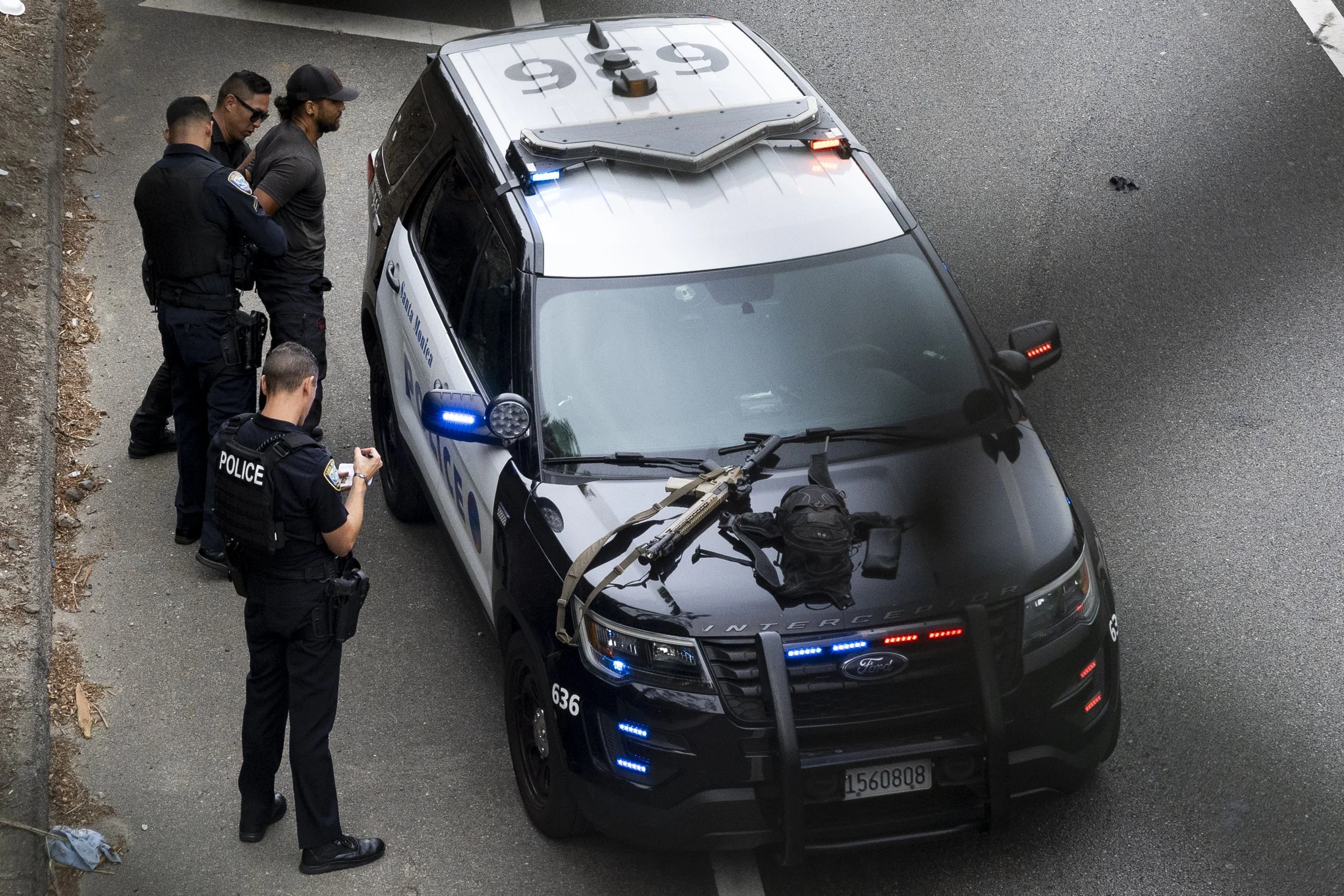 Santa Monica Police Department (SMPD)detains a man after it was reported he was carrying a firearm on the I-10 freeway embankment near 17 Street in Santa Monica, Calif., on Wednesday, Sept. 17, 2025. SMPD temporarily shut down both lanes of traffic