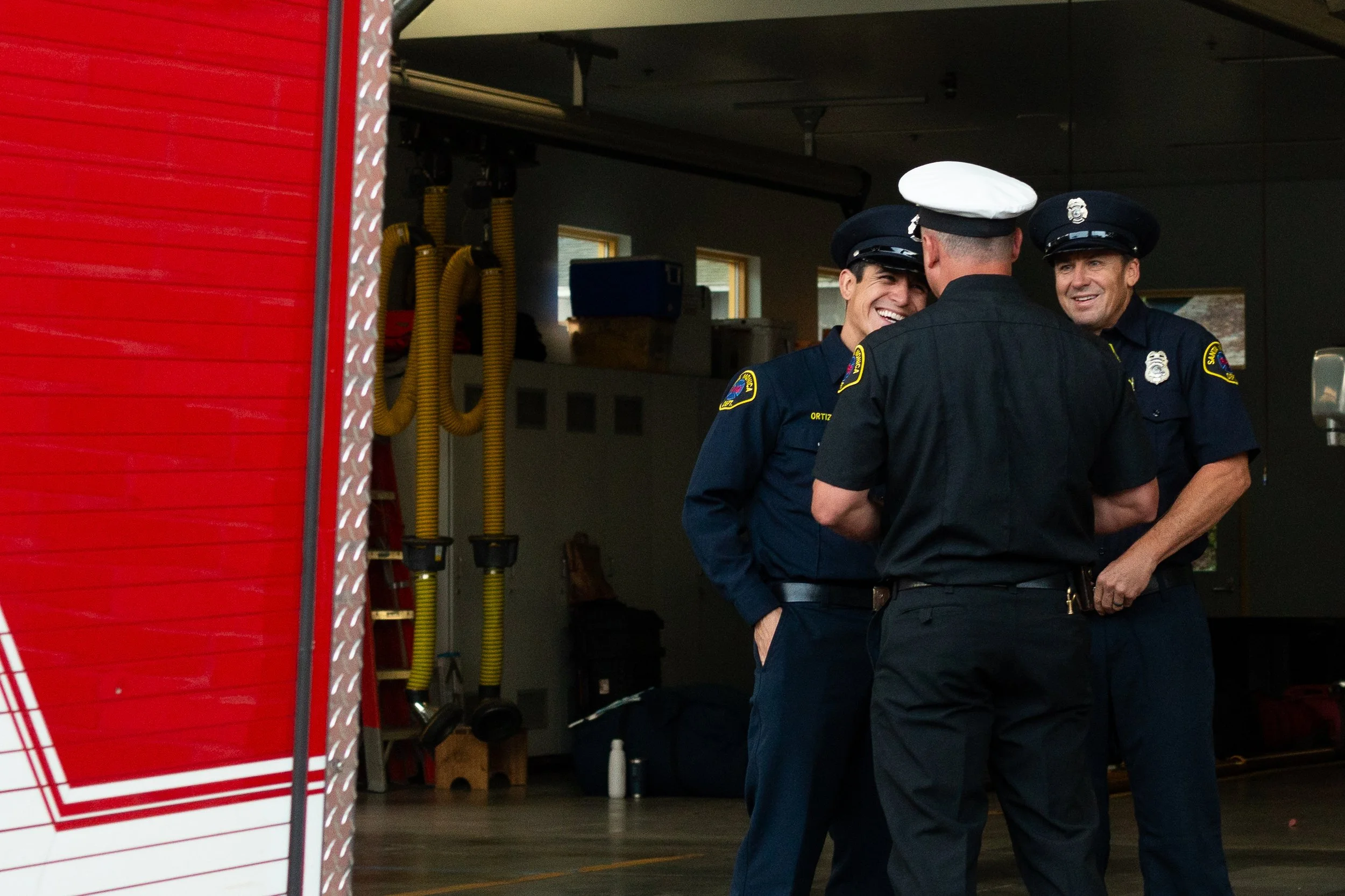 Danny Ortiz, a firefighter and paramedic with the Santa Monica Fire Dept. Station 2, shares a laugh with his fellow firefighters before the annual ceremony in honor of the National Day of Service and Remembrance commemorating the victims of the 9/11