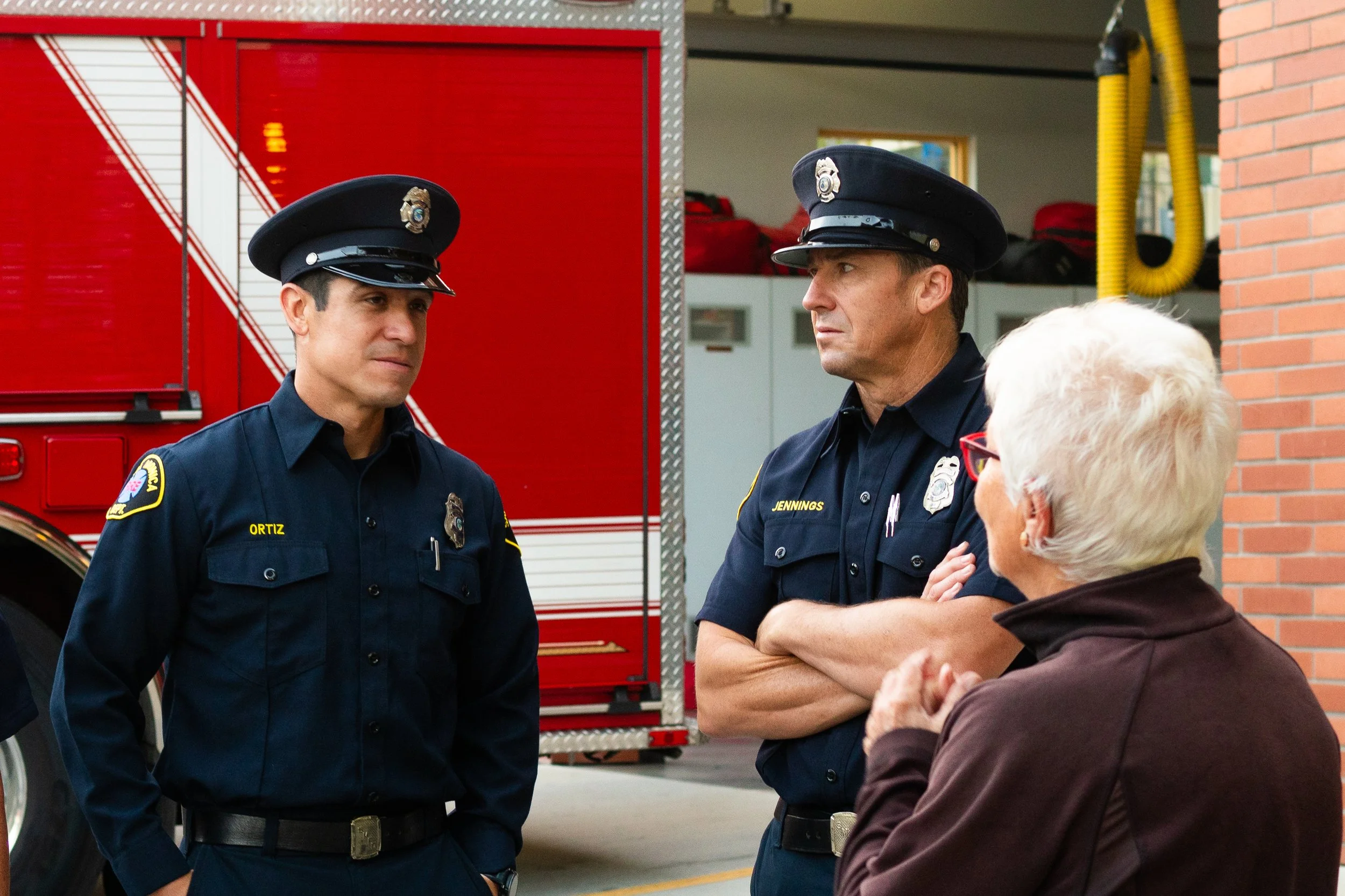 Danny Ortiz, a firefighter and paramedic with the Santa Monica Fire Dept. Station 2, chats with members of the community who attended the annual ceremony in honor of the National Day of Service and Remembrance commemorating the victims of the 9/11 t