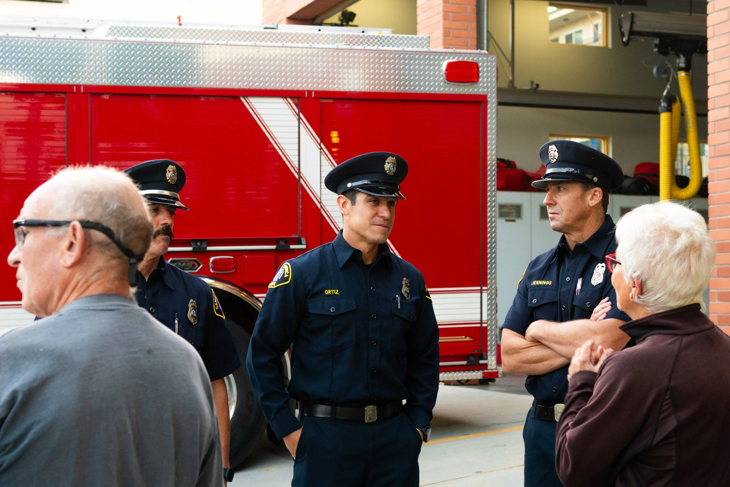 Danny Ortiz, a firefighter and paramedic with the Santa Monica Fire Dept. Station 2, chats with members of the community who attended the annual ceremony in honor of the National Day of Service and Remembrance commemorating the victims of the 9/11 t