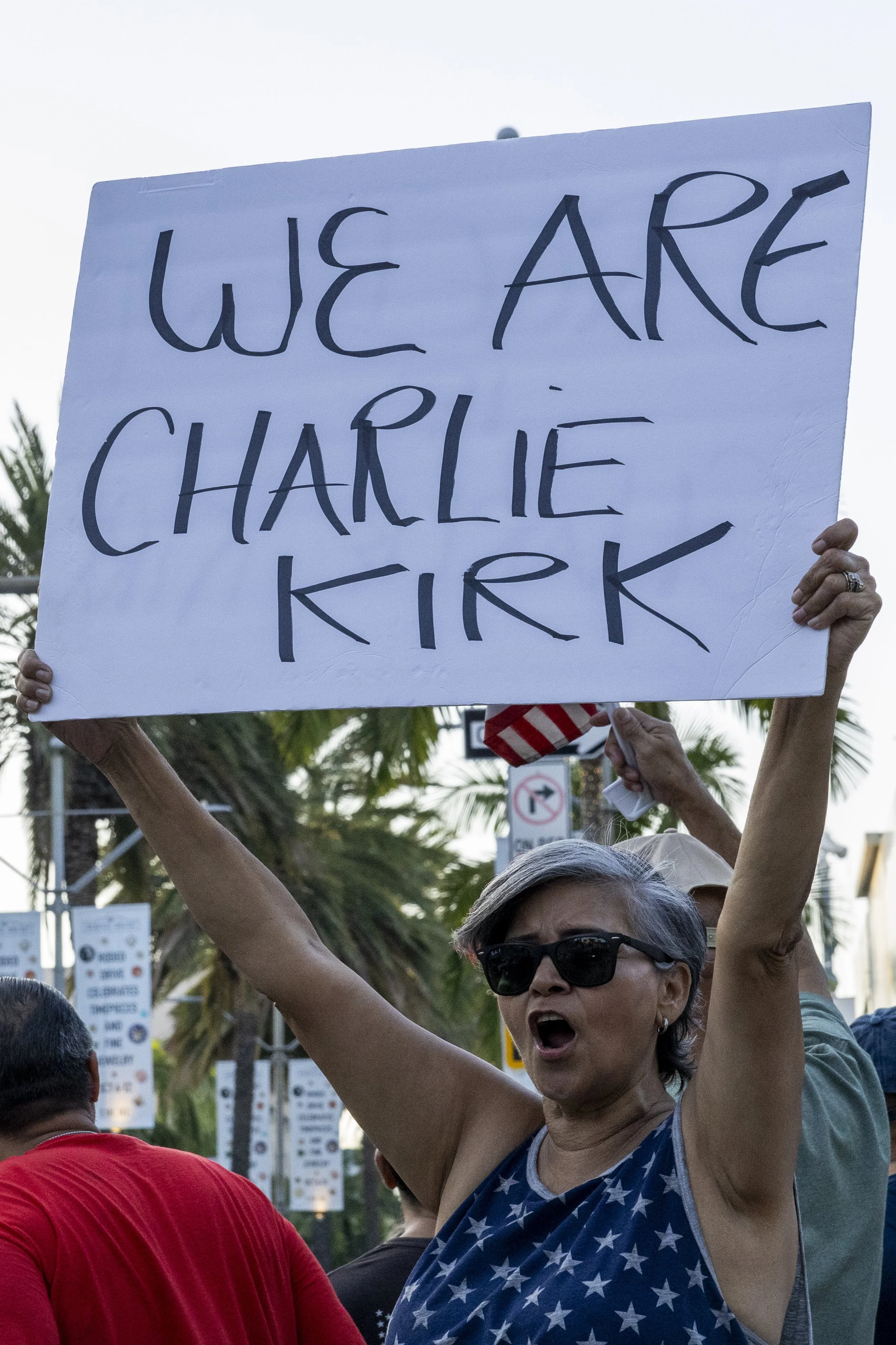 A woman holds up a “We are Charlie Kirk” sign at a vigil for Charlie Kirk held by the Beverly Hills Freedom Rally, a rightwing activist group, on Sunday, Sept 14, 2025, in Beverly Hills, Calif.(Jake Crandall | The Corsair)