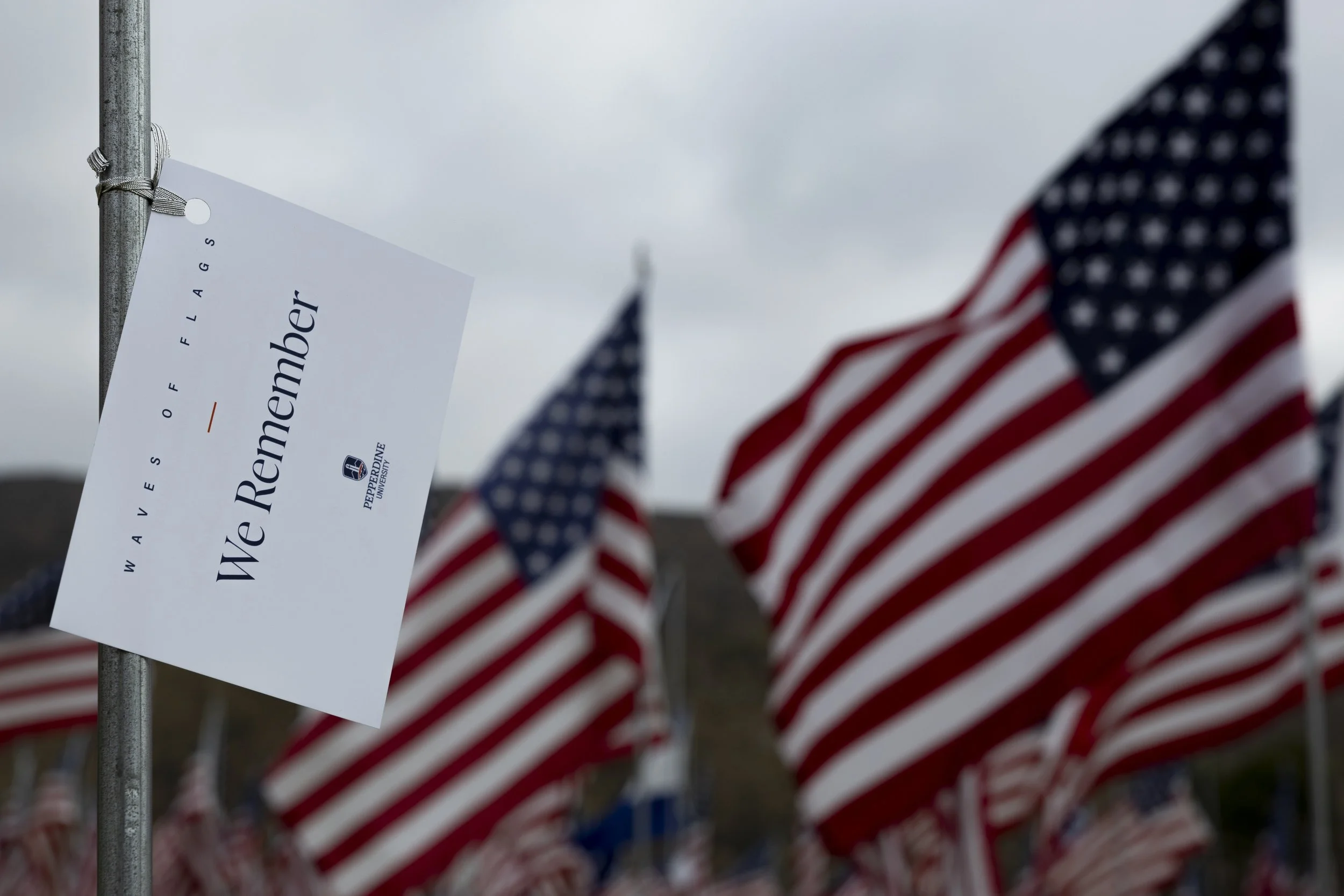 Flags dedicated to the 2,977 victims of 9/11 are displayed at Pepperdine University in Malibu, Calif., on Saturday, Sept. 13, 2025, with a flag representing an individual and their nationality. Handwritten messages are placed on each flag with the m