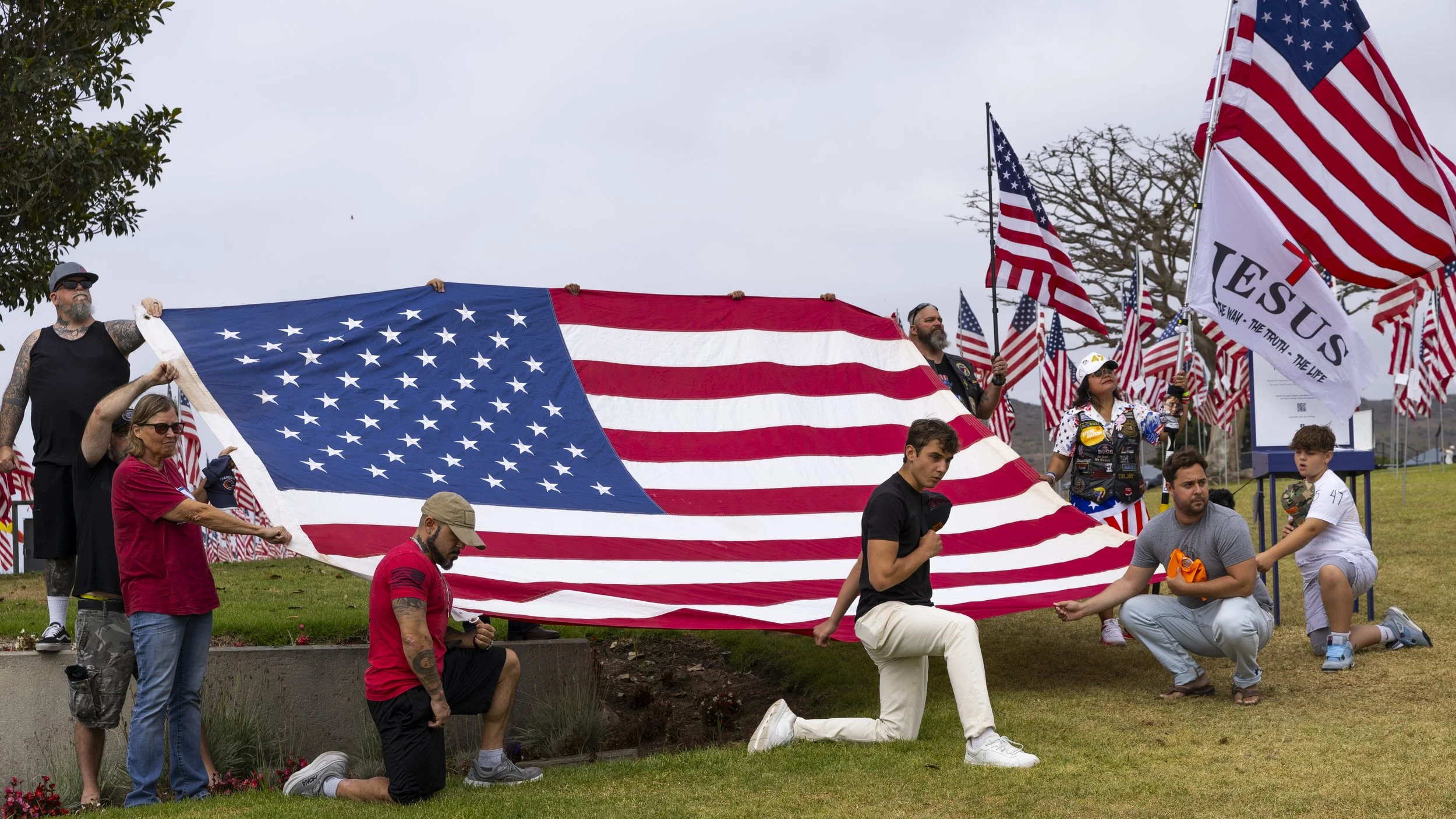 The 805 Patriots, a pro-Maga group, sing the American national anthem after gathering at Pepperdine University in Malibu, Calif., on Saturday, Sept. 13, 2025, for a remembrance cruise dedicated to the victims of 9/11 and Charlie Kirk.(Jake Crandall