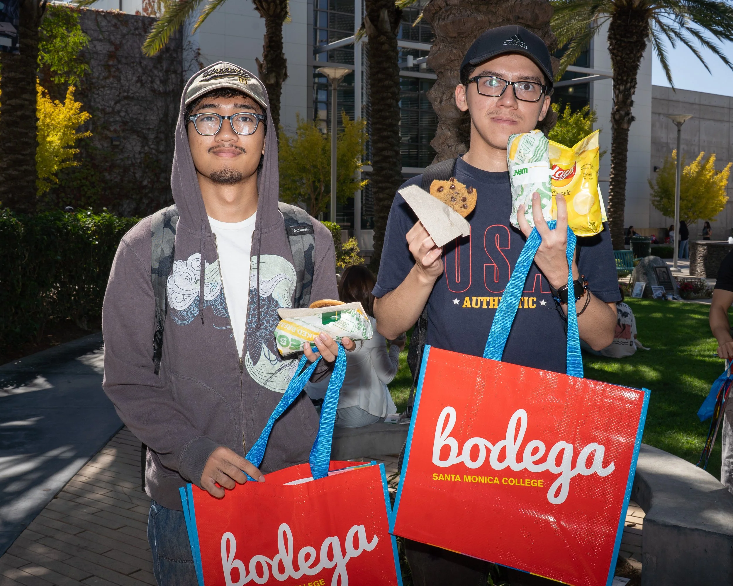 Santa Monica College first year students Fabio and Andrew hold up the free Subway and SMC Bodega Bags they recieved at the SMC Start Up on Tuesday Septemebr 16 in Santa Monica, Calif. Students filled out a survey and waited in line to receive their