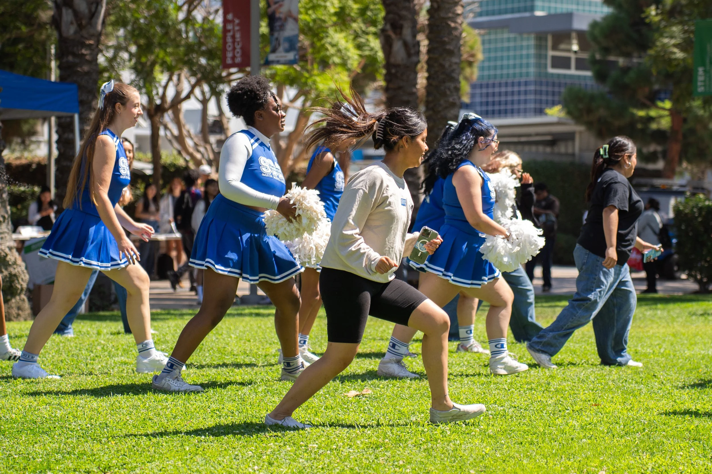 Santa Monica College (SMC) cheerleaders and students lead a group line dance to "Payaso de Rodeo" played by visiting Power 106 radio station DJ at the SMC Start Up on Tuesday September 16, 2025 in Santa Monica, Calif. The SMC Start Up event, typicia