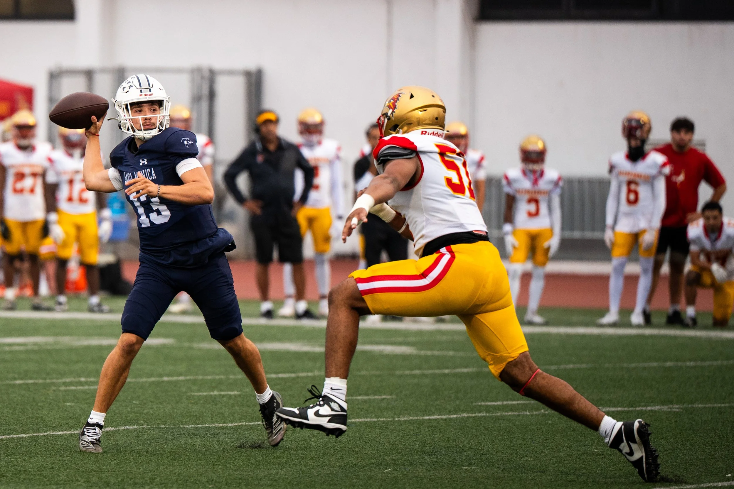 Santa Monica College (SMC) Corsair (13) QB Dylan Moreno dropping back to pass as College of the Desert Roadrunner (51) DE Tyrese McKneely rushing in on Saturday, September 20, 2025, Santa Monica,Calif. The Corsairs won 66-28. (Tom Rosholt | The Cors