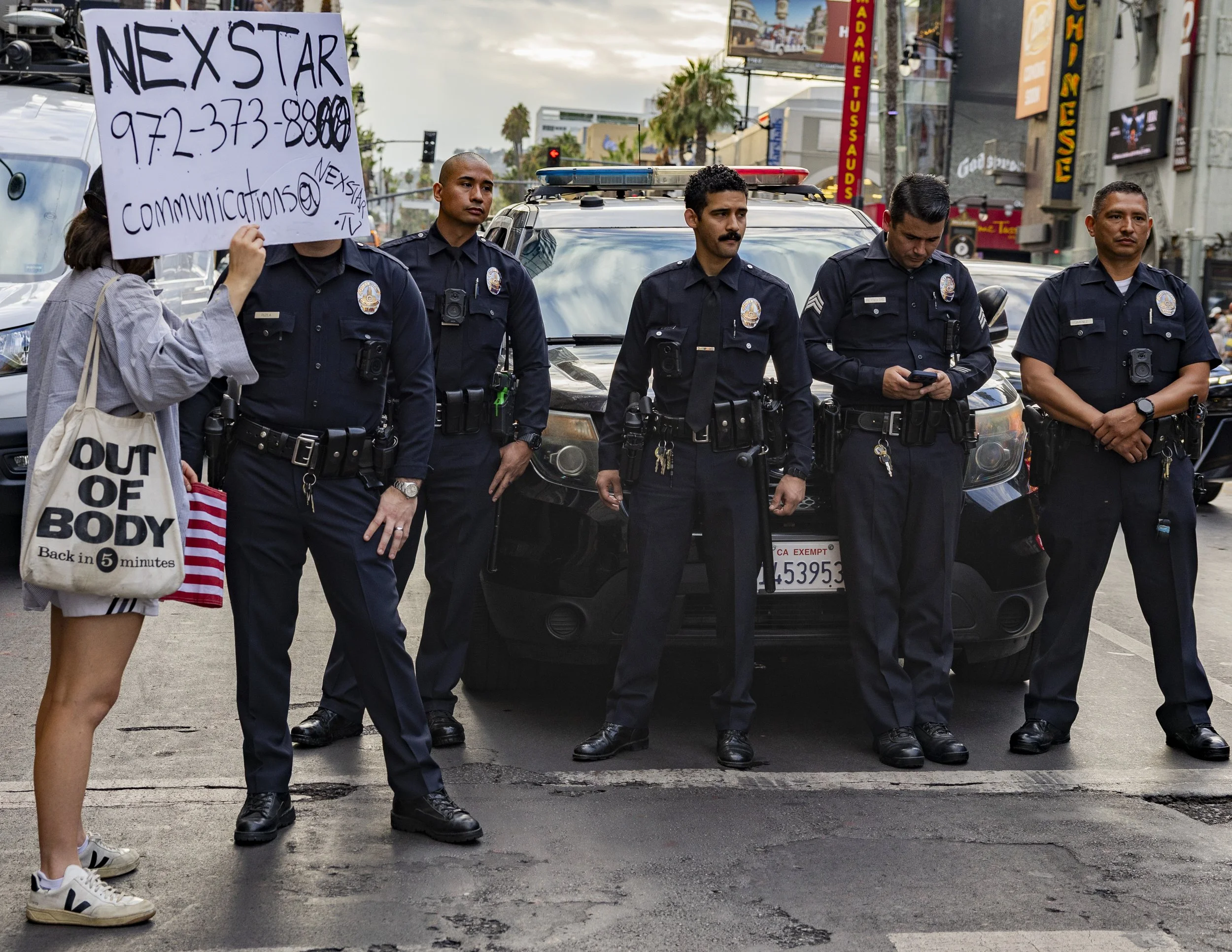 A protester displayed a sign with Nexstar Media Group’s contact information outside El Capitan Entertainment Centre in Hollywood, Calif., on Thursday, Sept. 18, to protest the cancellation of Jimmy Kimmel’s late-night talk show, “Jimmy Kimmel Live,”
