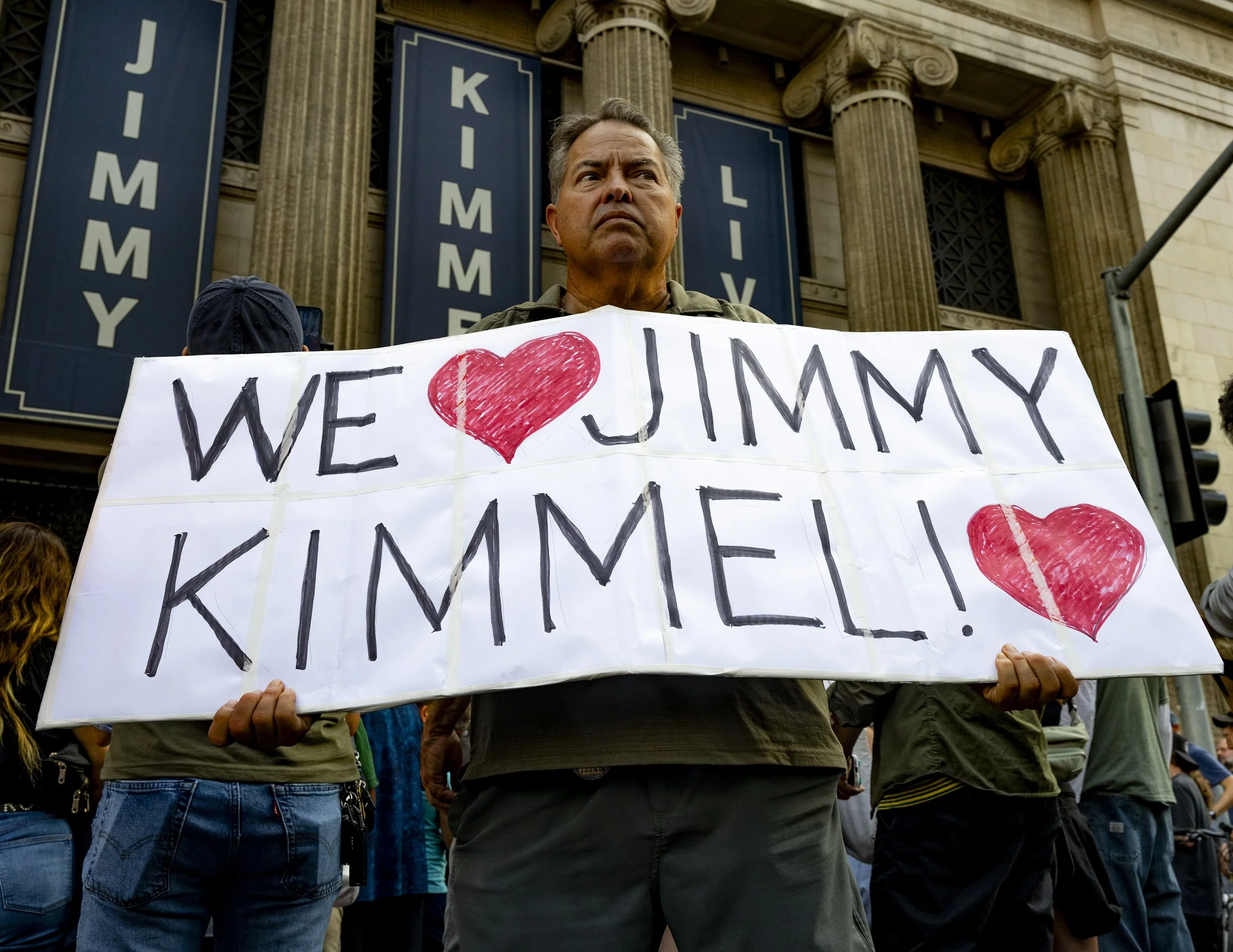 A protester held a sign outside El Capitan Entertainment Centre in Hollywood, Calif., on Thursday, Sept. 18, to protest the cancellation of Jimmy Kimmel’s late-night talk show, “Jimmy Kimmel Live,” after ABC indefinitely suspended the show following