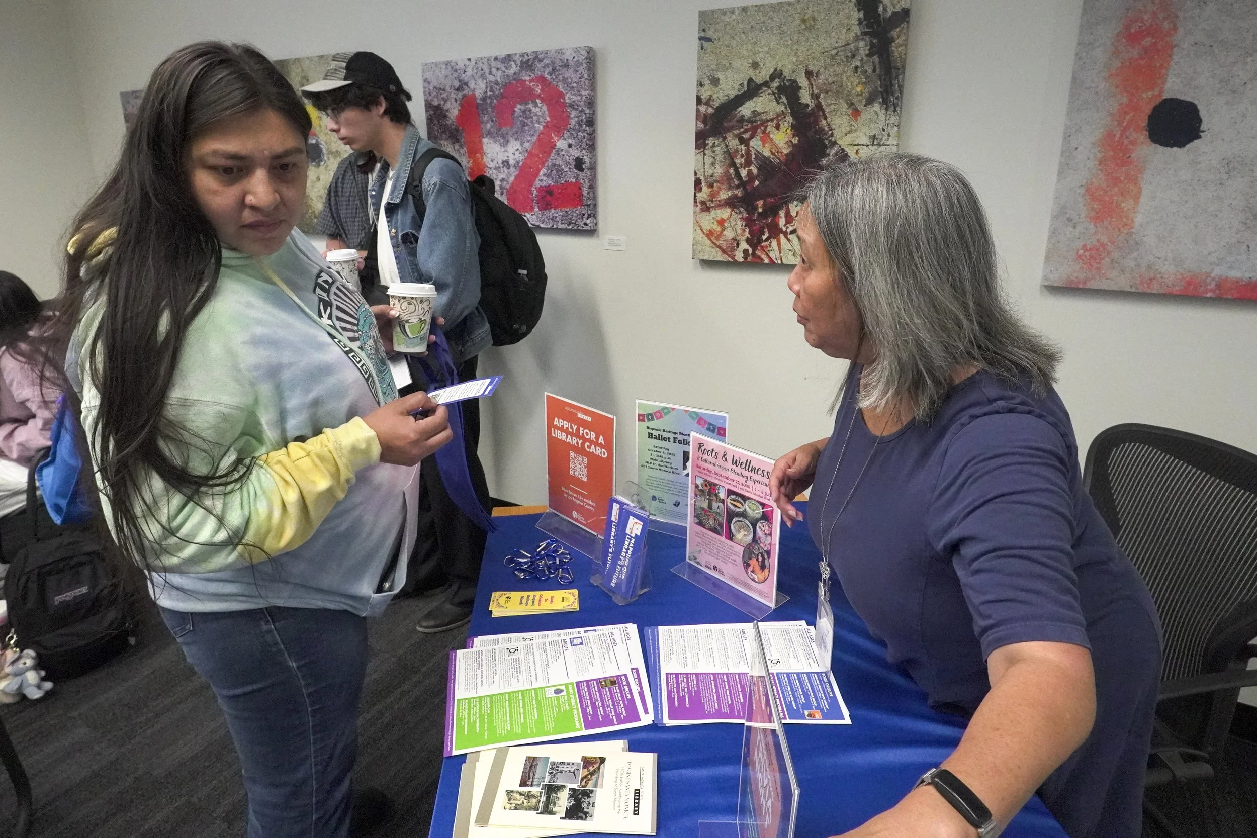 Santa Monica College (SMC) student Sandra Deleon (left) gathered information from librarian Barbara Fleeman (right) at the Coffee with Librarians event on Thursday, Sept. 19, 2025 at the SMC library, Santa Monica, Calif. The event enabled librarians