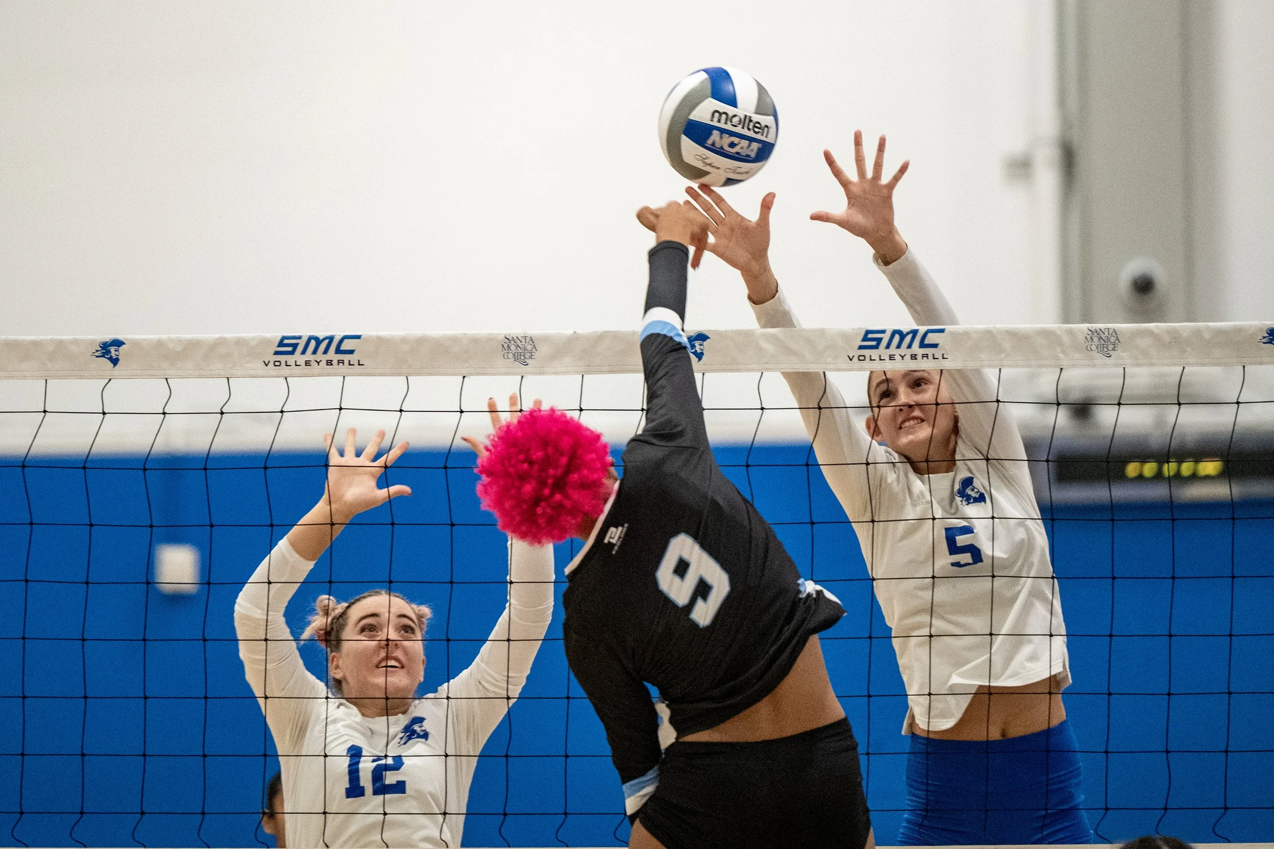 Santa Monica College (SMC) Corsairs’ (L to R) setter (12) Makena Gamby and middle blocker (5) Nicole Lankton blocking Moorpark College Raiders middle blocker (9) Genessa Johnson on Friday, September 19, 2025, Santa Monica,Calif. The Corsairs won the