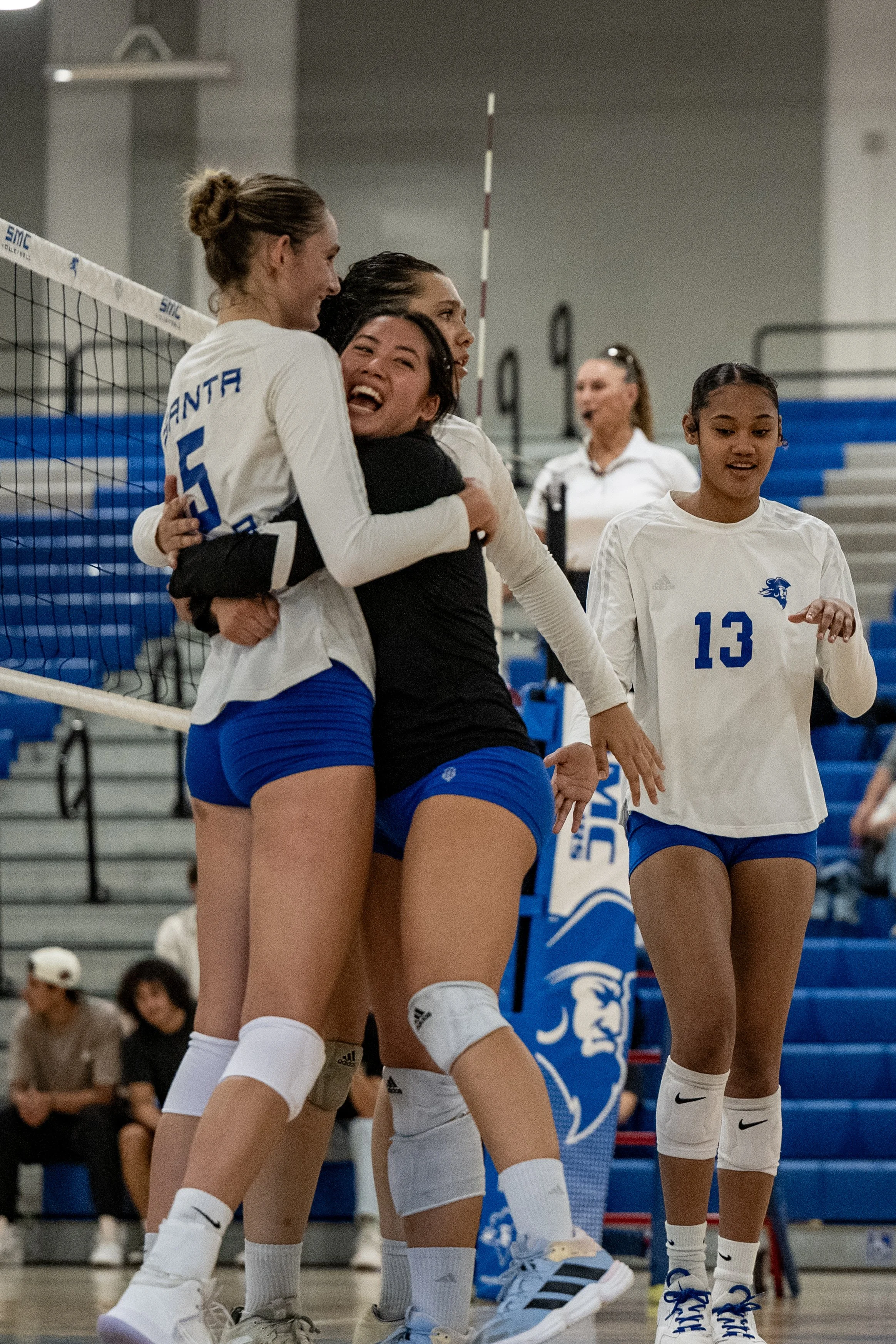 Santa Monica College (SMC) Corsairs (L to R) middle blocker (5) Nicole Lankton and left back (7) Annah Legaspi embracing after lead taking point on Friday, September 19, 2025, Santa Monica,Calif. The Corsairs won the match 3-2. (Tom Rosholt | The Co