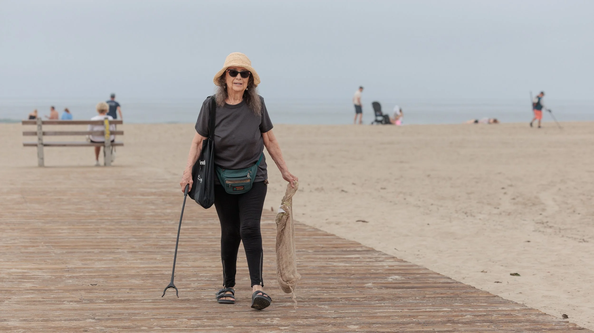 Regina Urbina picks up trash and debris at the 36th annual Coastal Cleanup Day on Saturday Sept. 20, 2025 in Santa Monica, Calif. Urbina has lived in Santa Monica for 35 years. "I love the beach," says Urbina. "It's a great excuse for being on the b
