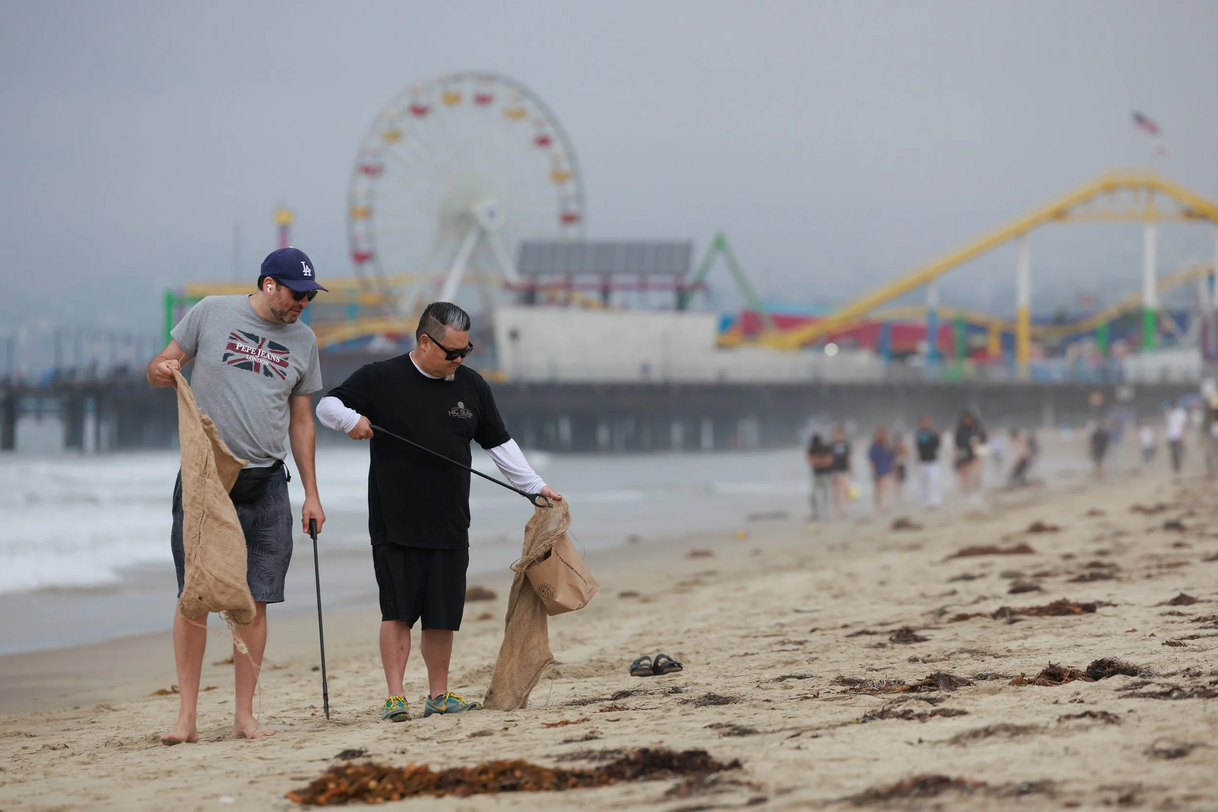 (L to R) Hanoch Serebrenik and Darren Kawaoka pick up trash and debris at the 36th annual Coastal Cleanup Day on Saturday Sept. 20, 2025 in Santa Monica, Calif. "It's really great to see how many people have showed up and want to contribute to the h