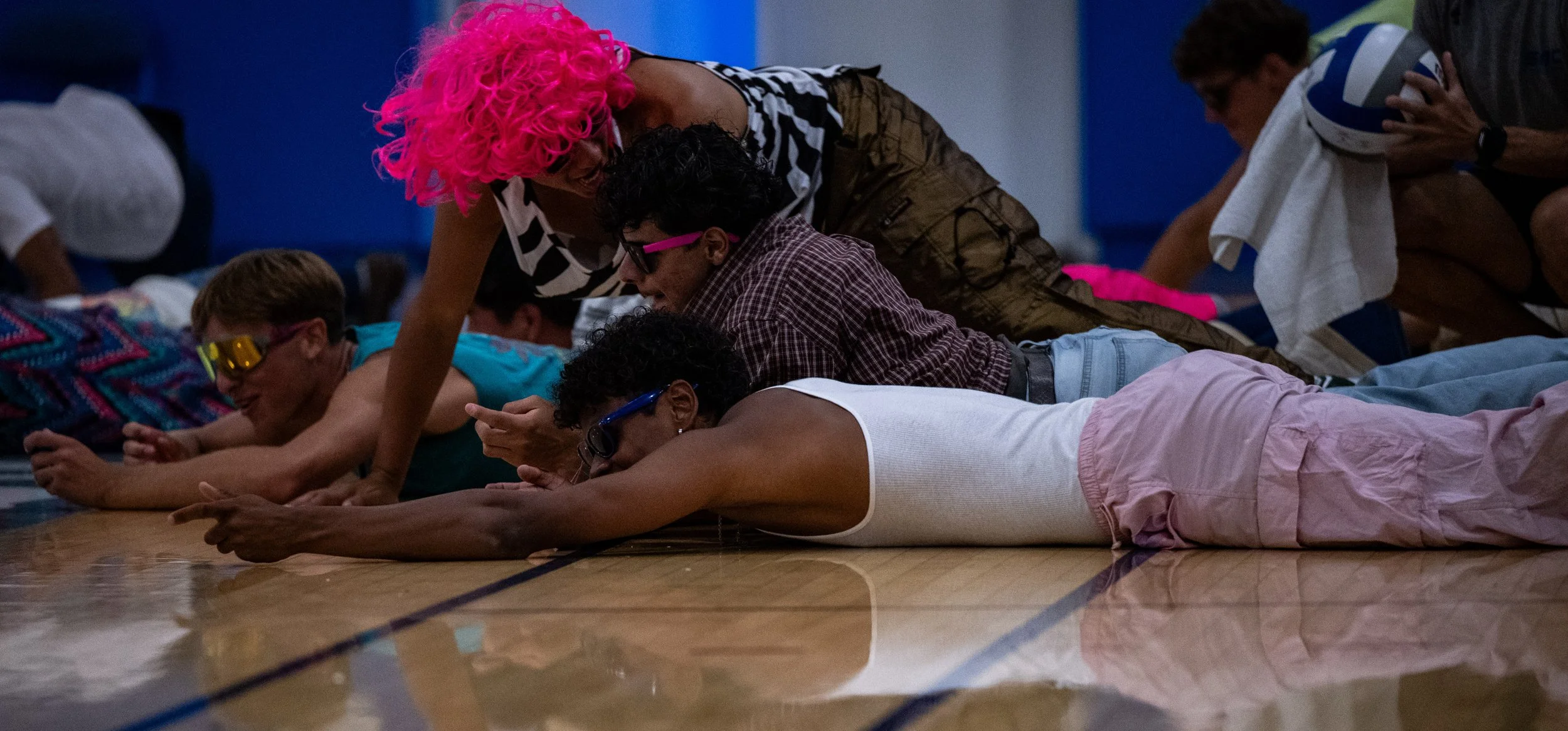  Santa Monica College (SMC) Corsair men’s volleyball team, dressed for 80’s, night dive on the ground in celebration for women’s team scoring on Wednesday, October 1, 2025, Santa Monica,Calif.  The Corsairs won the match 3-0. (Tom Rosholt | The Corsa