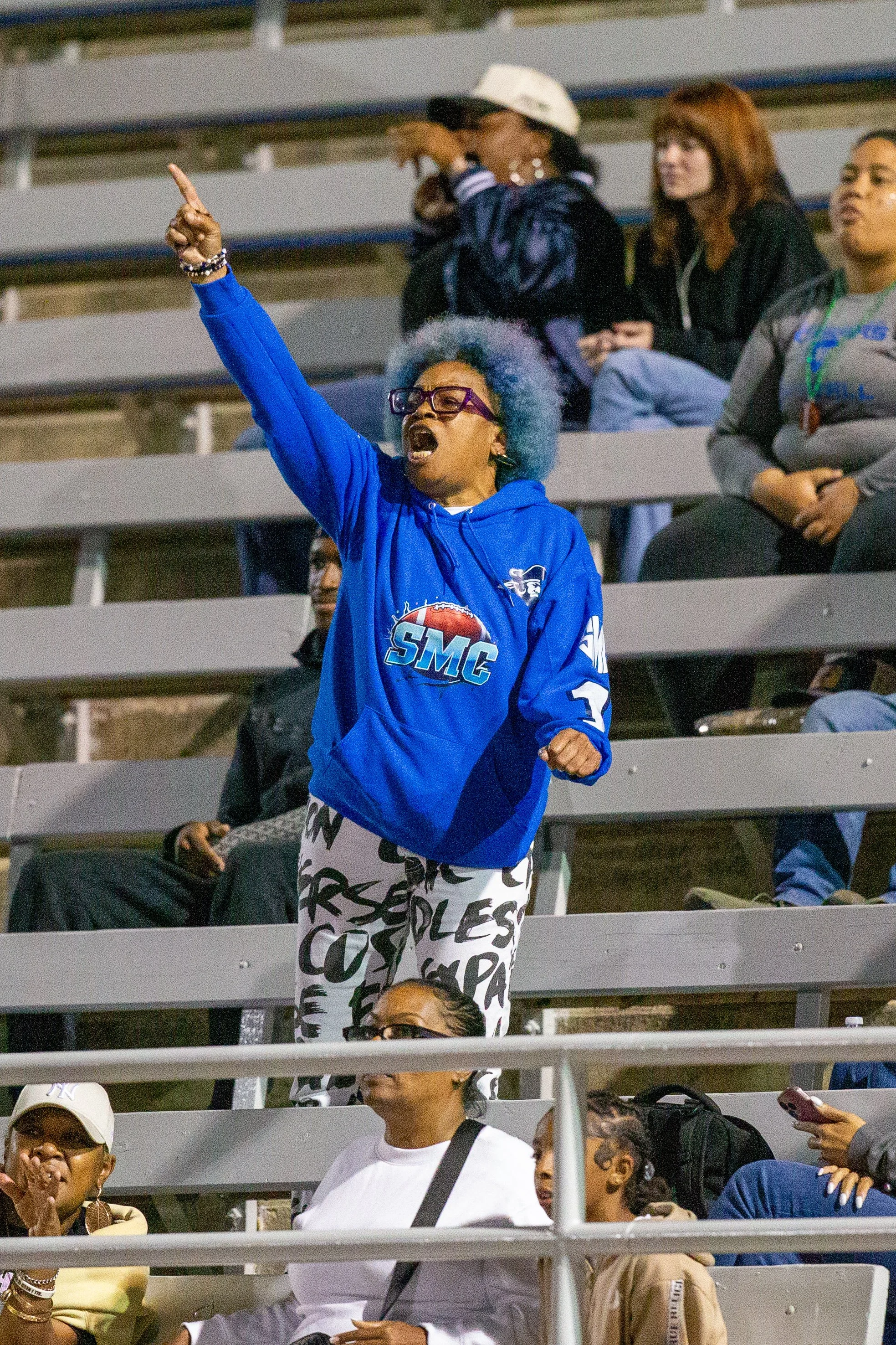 Ex-Santa Monica College (SMC) cheerleading coach Michelle Benson yelling towards the referees "Kick Him Off" due to an L.A. Pierce College Brahmas player ripping off a SMC Corsairs player's helmet on the last play at SMC Corsair Stadium, Santa Monic