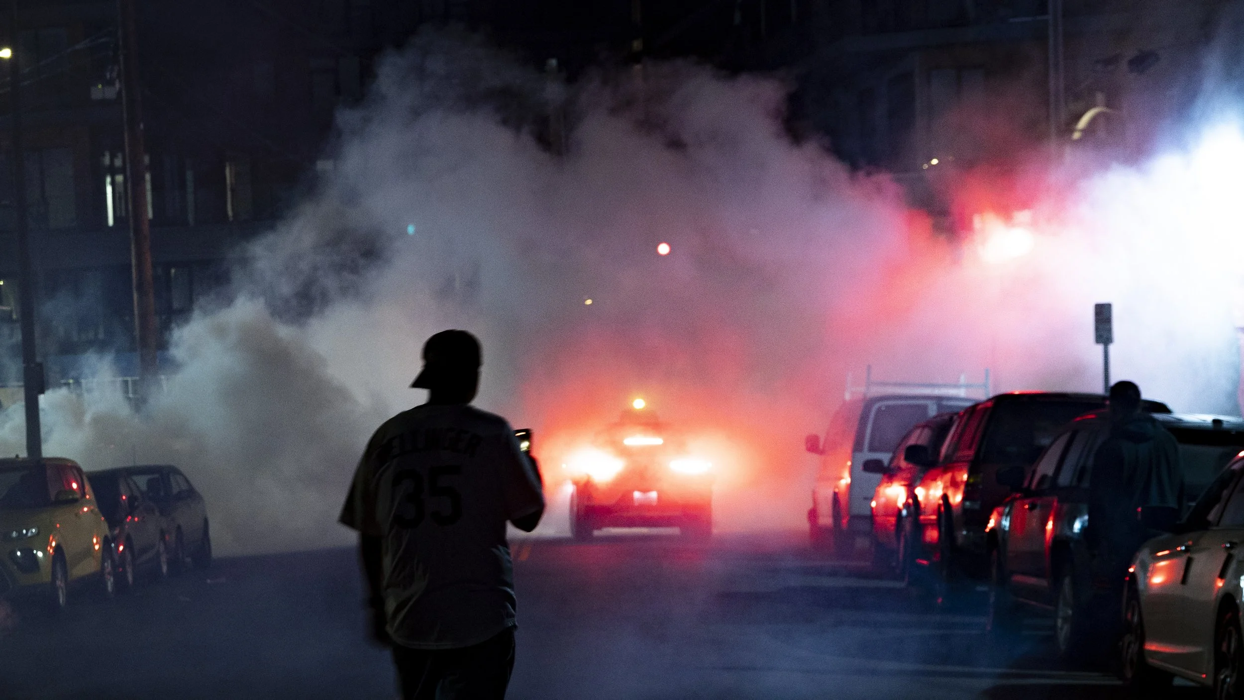  A Dodger fan walks towards tear gas on Saturday, Nov. 1, 2025, during a street takeover to celebrate the Dodgers' Game 7 of the 2025 MLB World Series win. (Kayjel J. Mairena | The Corsair) 