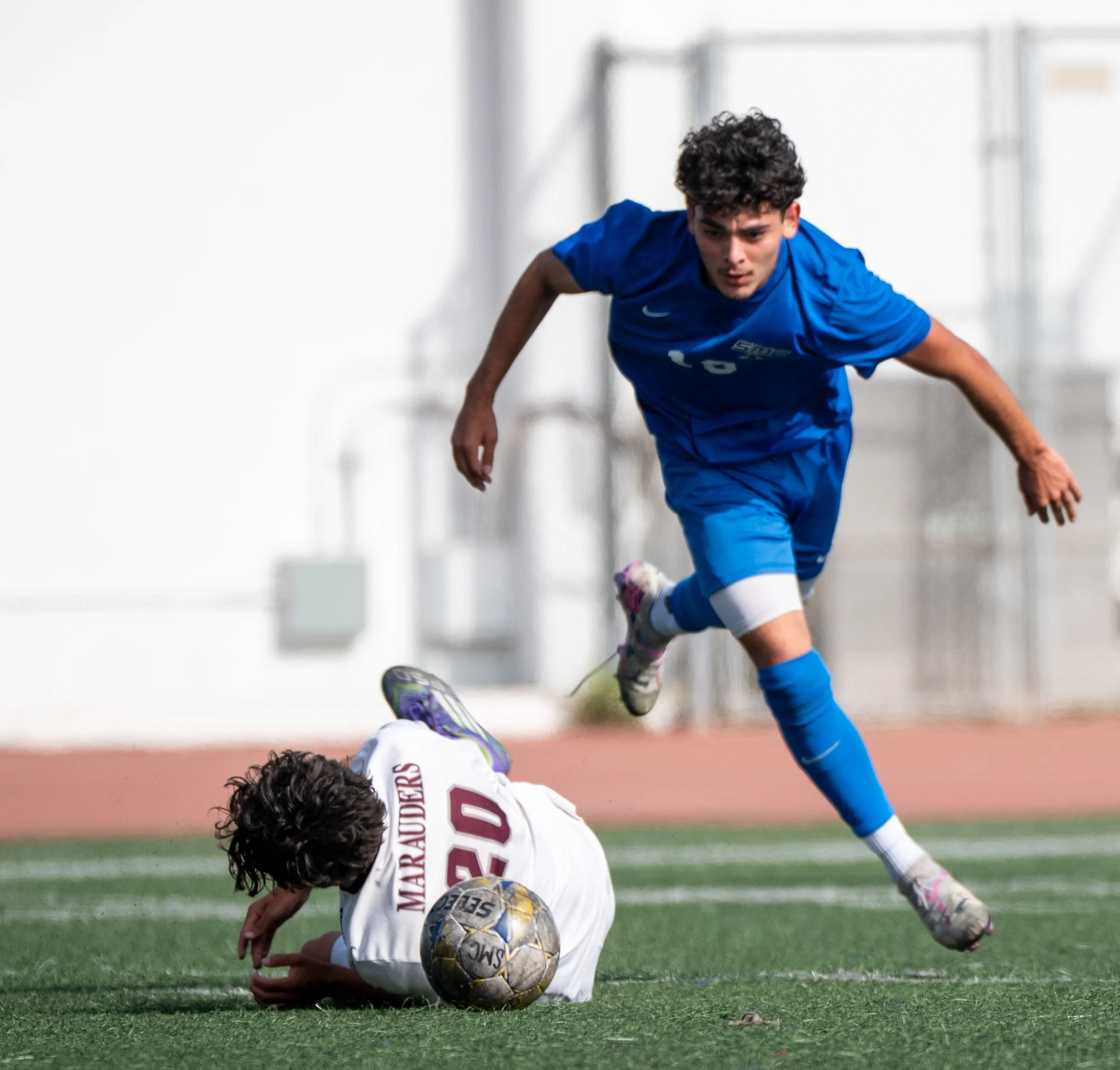  Santa Monica College (SMC) Corsair midfielder (19) Henry Carrera being tackled by Antelope Valley College Marauder (20) Aidan Garcia on Tuesday,  November 4, 2025, Santa Monica, Calif. The Corsairs won the4-0. (Tom Rosholt | The Corsair) 