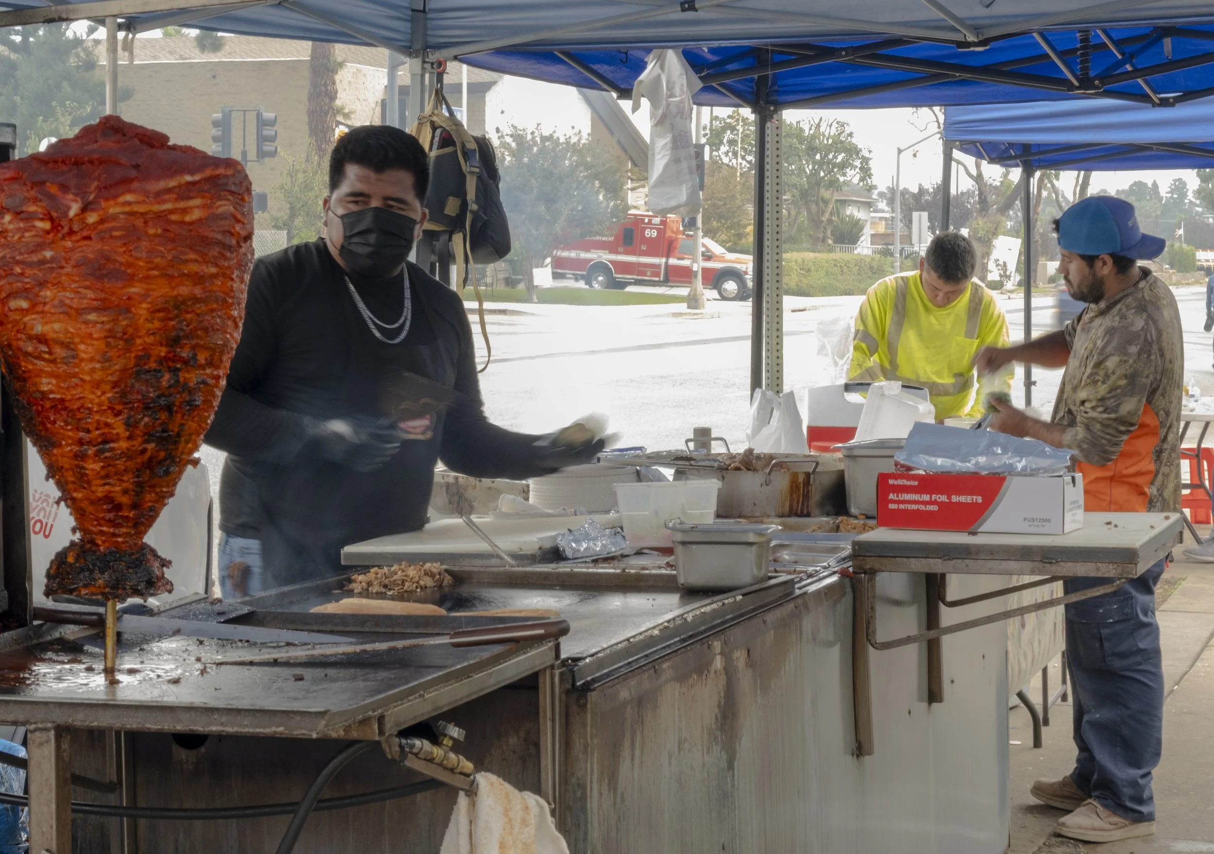  A taco vendor sells lunch to construction workers near Fire House 69 in Pacific Palisades neighborhood of Los Angeles, Calif., on Wednesday, Nov. 12, 2025. Street vendors have become a staple in the area for workers, as few restaurants and stores ar