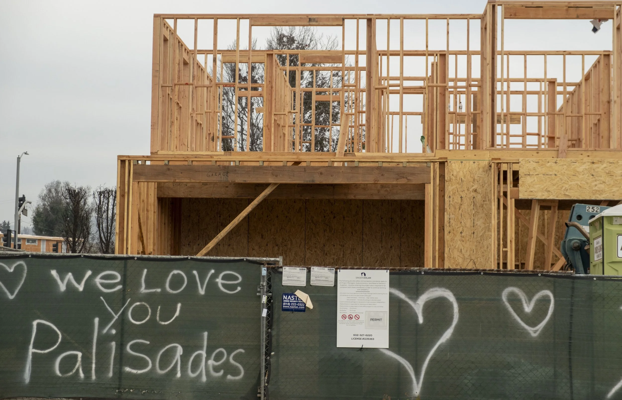  A house frame rises behind a “we love you Palisades” sign, Wednesday, Nov. 12, 2025, in Pacific Palisades neighborhood of Los Angeles, Calif. After eight months of debris cleanup, residents are beginning to rebuild.  (Fai Fong | The Corsair) 