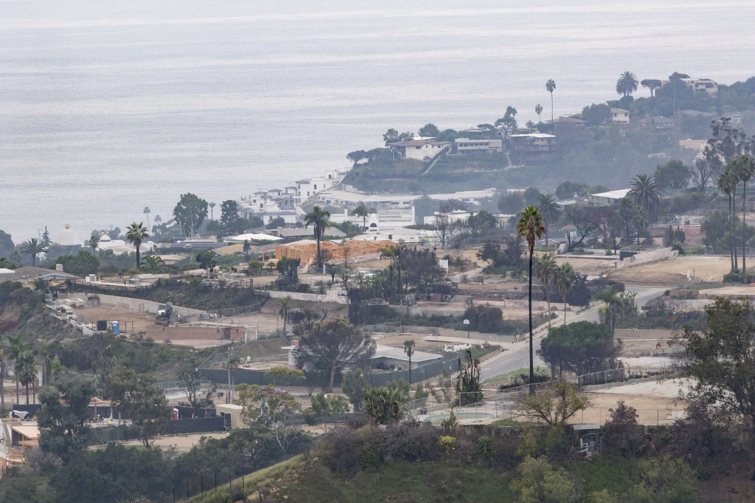  A constructed house frame sits among empty lots in Pacific Palisades neighborhood of Los Angeles, Calif., on Wednesday, Nov. 12, 2025. After eight months of debris cleanup, residents are beginning to rebuild. (Fai Fong | The Corsair) 