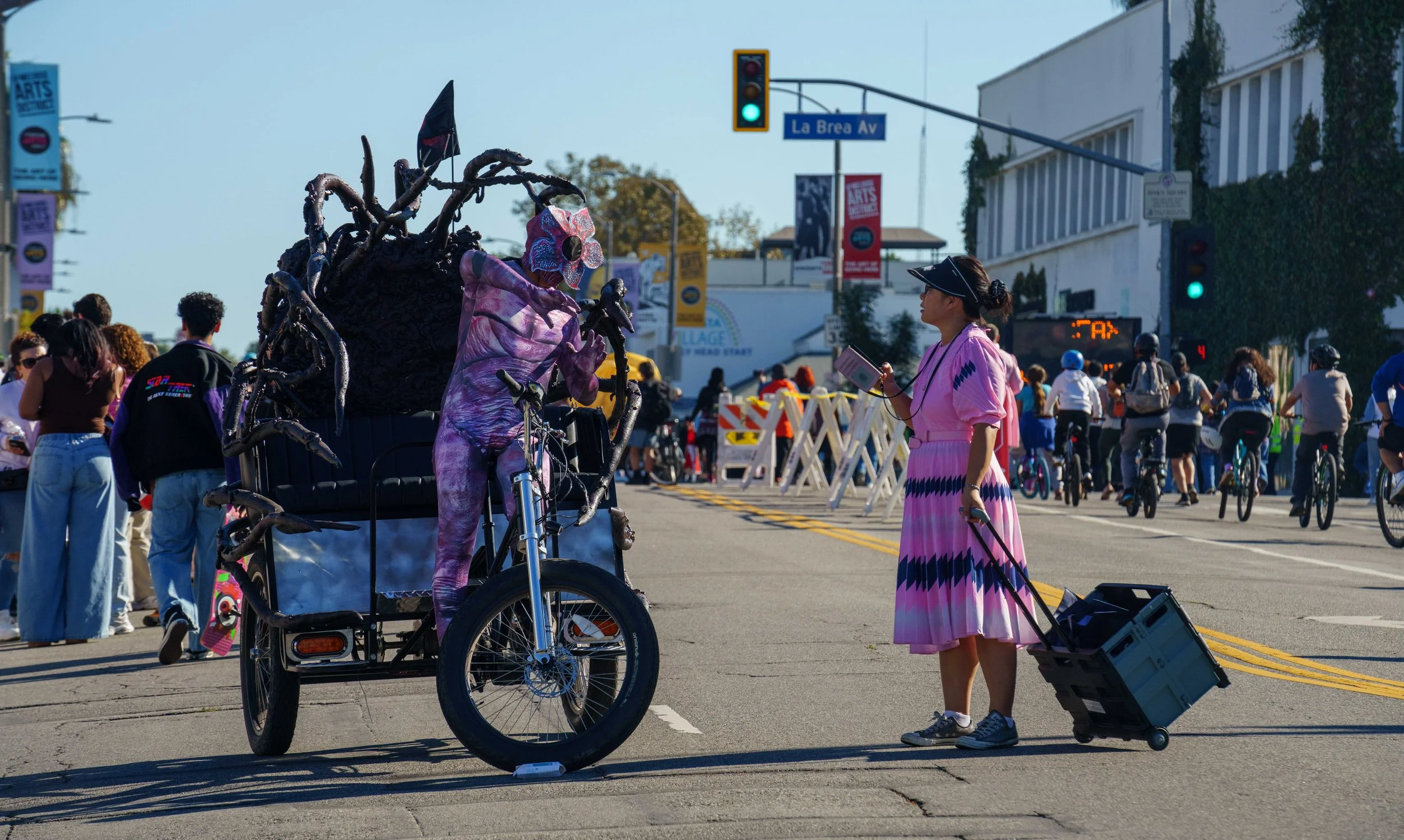  Pedicab driver Armando Ramirez (L), dressed as the Demogorgon from the Netflix show Stranger Things, speaks with a pedestrian during Netflix x CicLAvia - Melrose Ave: Stranger Things 5 “One Last Ride” event on Sunday, Nov. 23, 2025, at the intersect