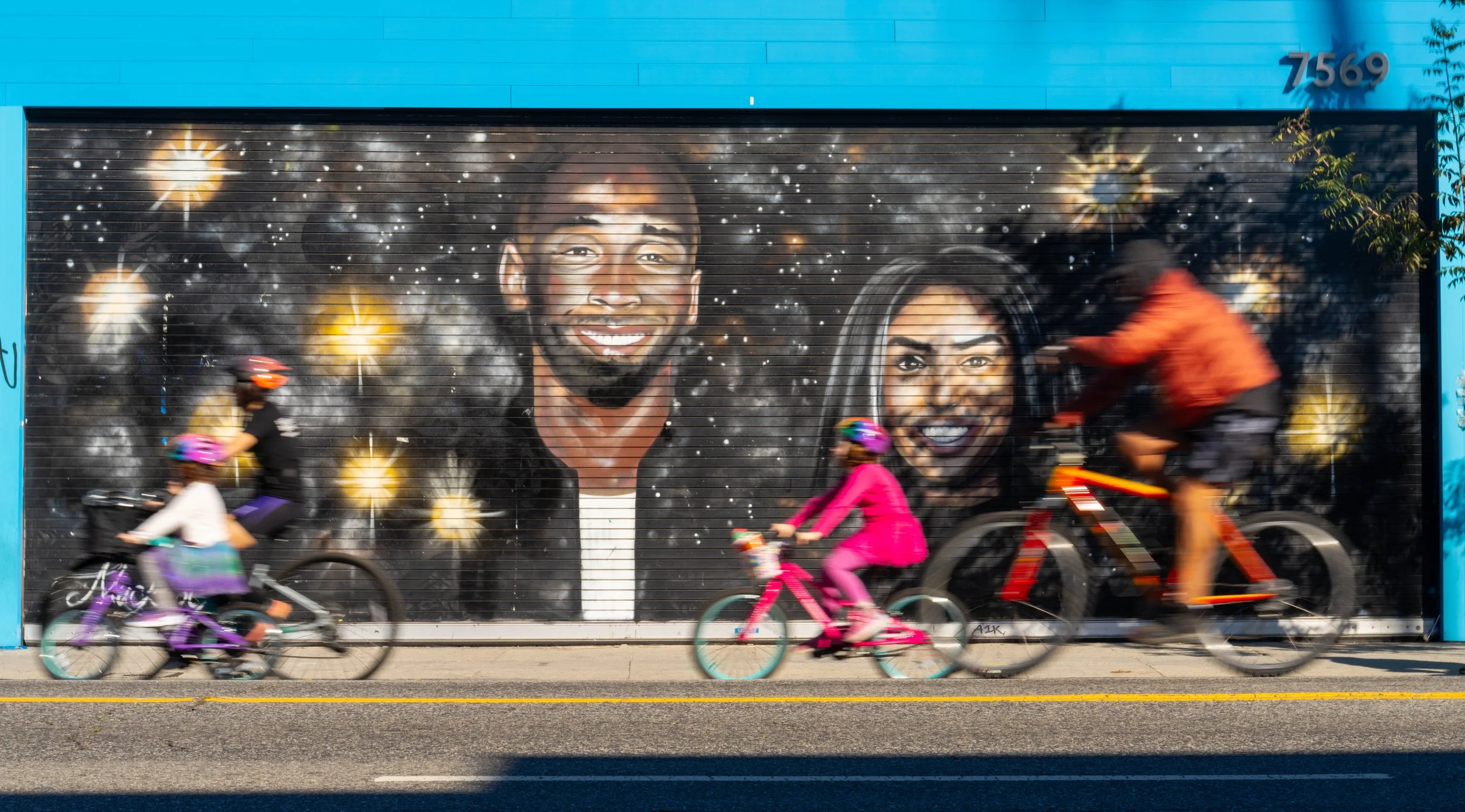  Cyclists ride past a mural of Kobe and Gianna Bryant on a car-free Melrose Avenue during Netflix x CicLAvia - Melrose Ave: Stranger Things 5 “One Last Ride” event on Sunday, Nov. 23, 2025, in Los Angeles, Calif. The event celebrated the release of t
