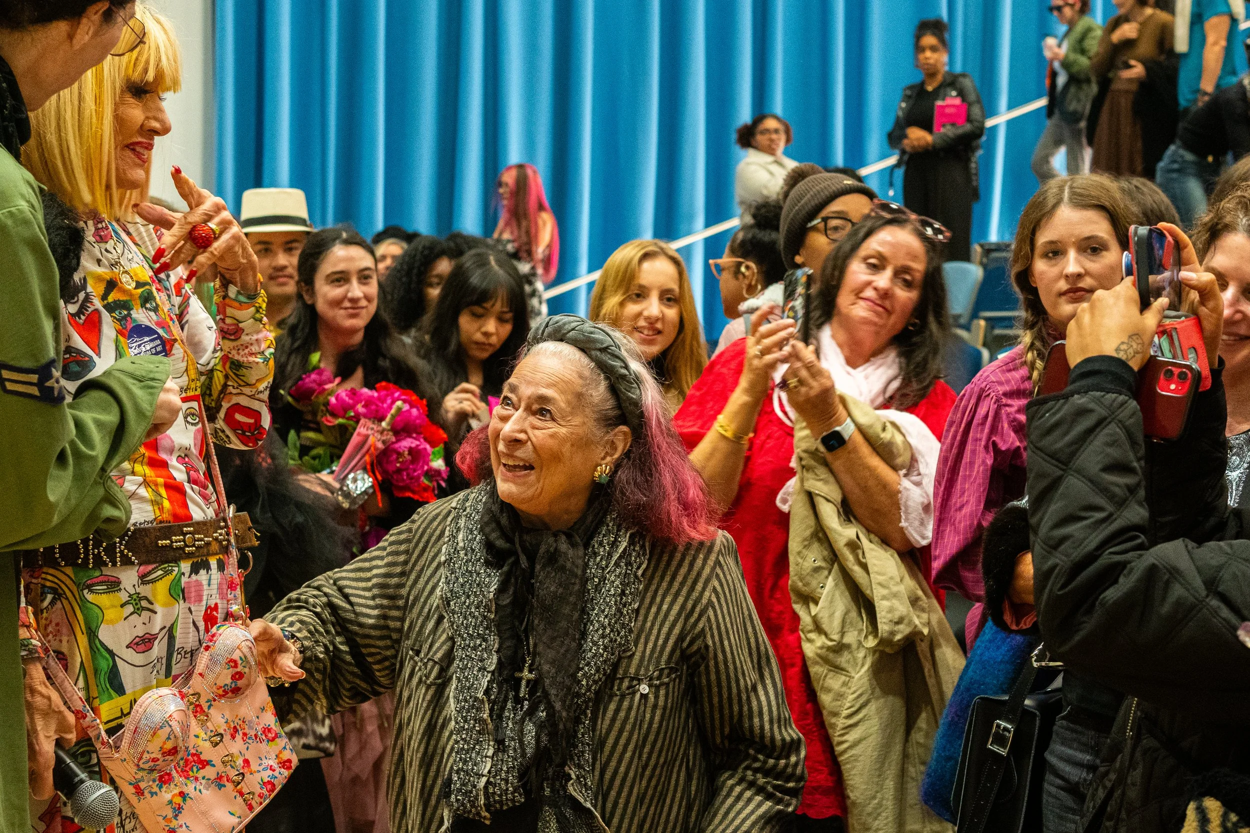  Crowds gather to greet fashion designer Betsey Johnson shortly after her talk concluded in the Student Services Center, Monday, Nov. 17, 2025, on the Santa Monica College (SMC) campus in Santa Monica, Calif. (Nathan Hanson | The Corsair) 