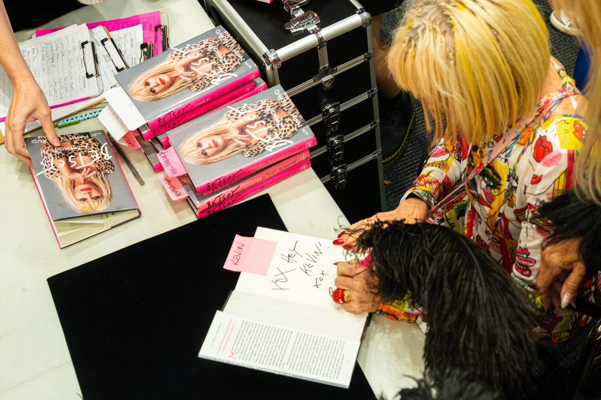  Fashion designer Betsey Johnson signs copies of her memoir, titled Betsey: A Memoir, co-written by Johnson and freelance writer Mark Vitulano, shortly after her talk concluded in the Student Services Center, Monday, Nov. 17, 2025, on the Santa Monic