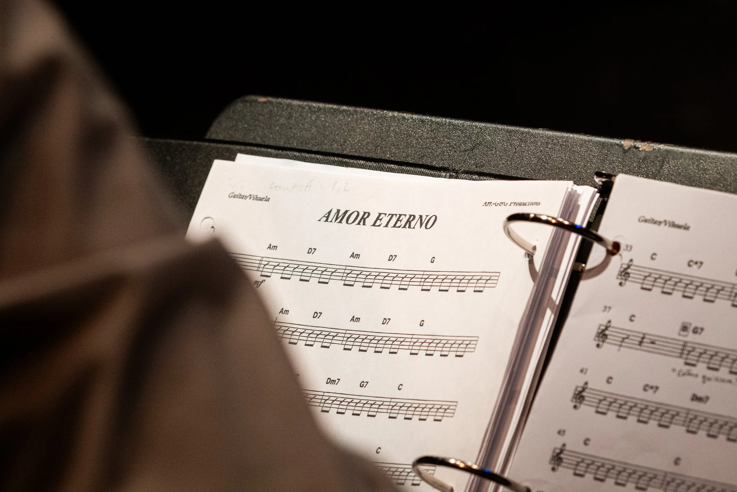  Mary Alfaro, the instructor for the Mariachi Ensemble class at Santa Monica College (SMC), opens her music book to the song “Amor Eterno,” a ballad about grief, loss and maternal love, during a free concert at The Eyde Second Space at the SMC Perfor