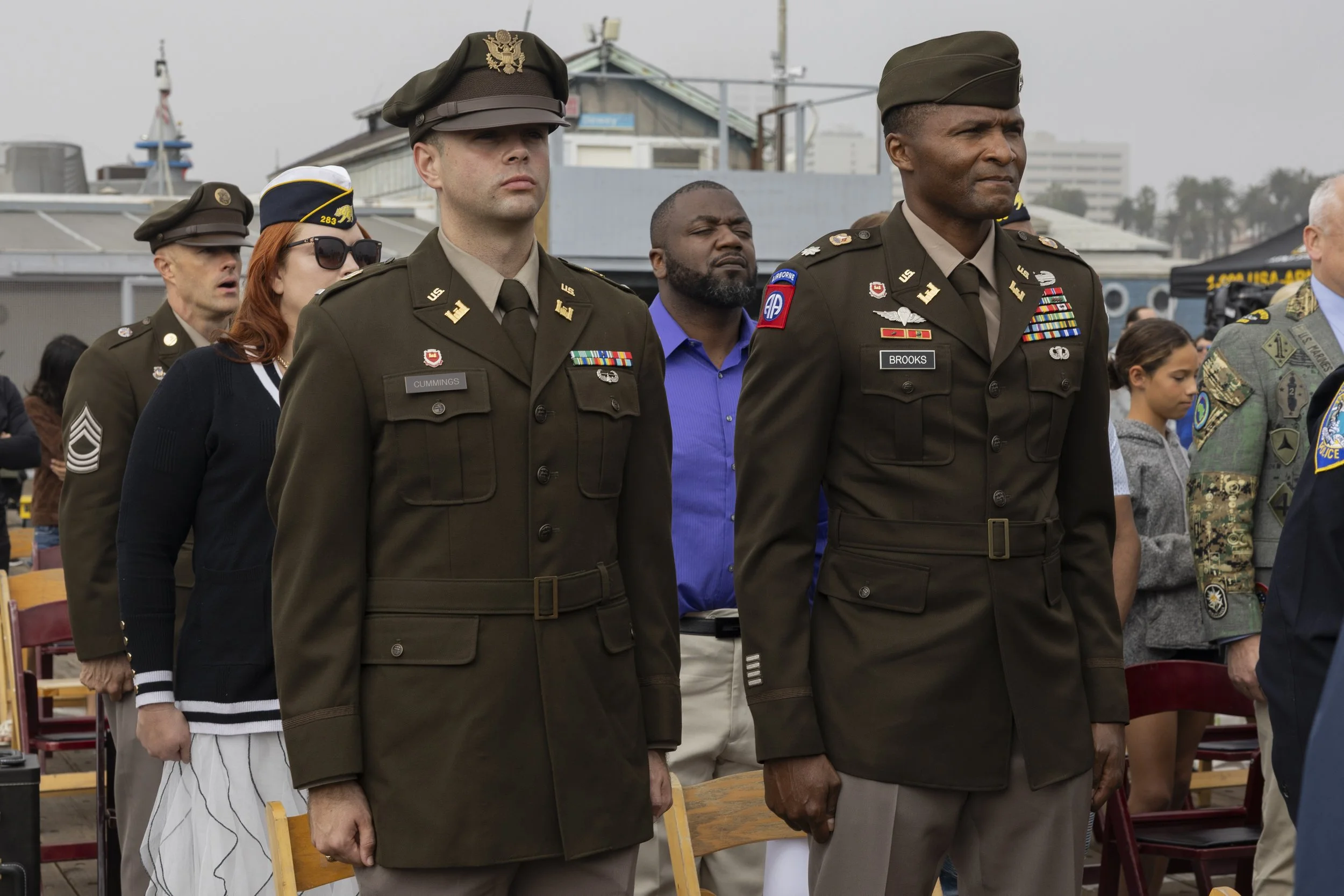  Army veterans stand at attention, while the James Monroe High School Junior Reserve Officers’ Training Corps performs a posting of colors at the Santa Monica Pier in Santa Monica, Calif., on Tuesday, Nov. 11, 2025, during a Veterans Day ceremony. (K