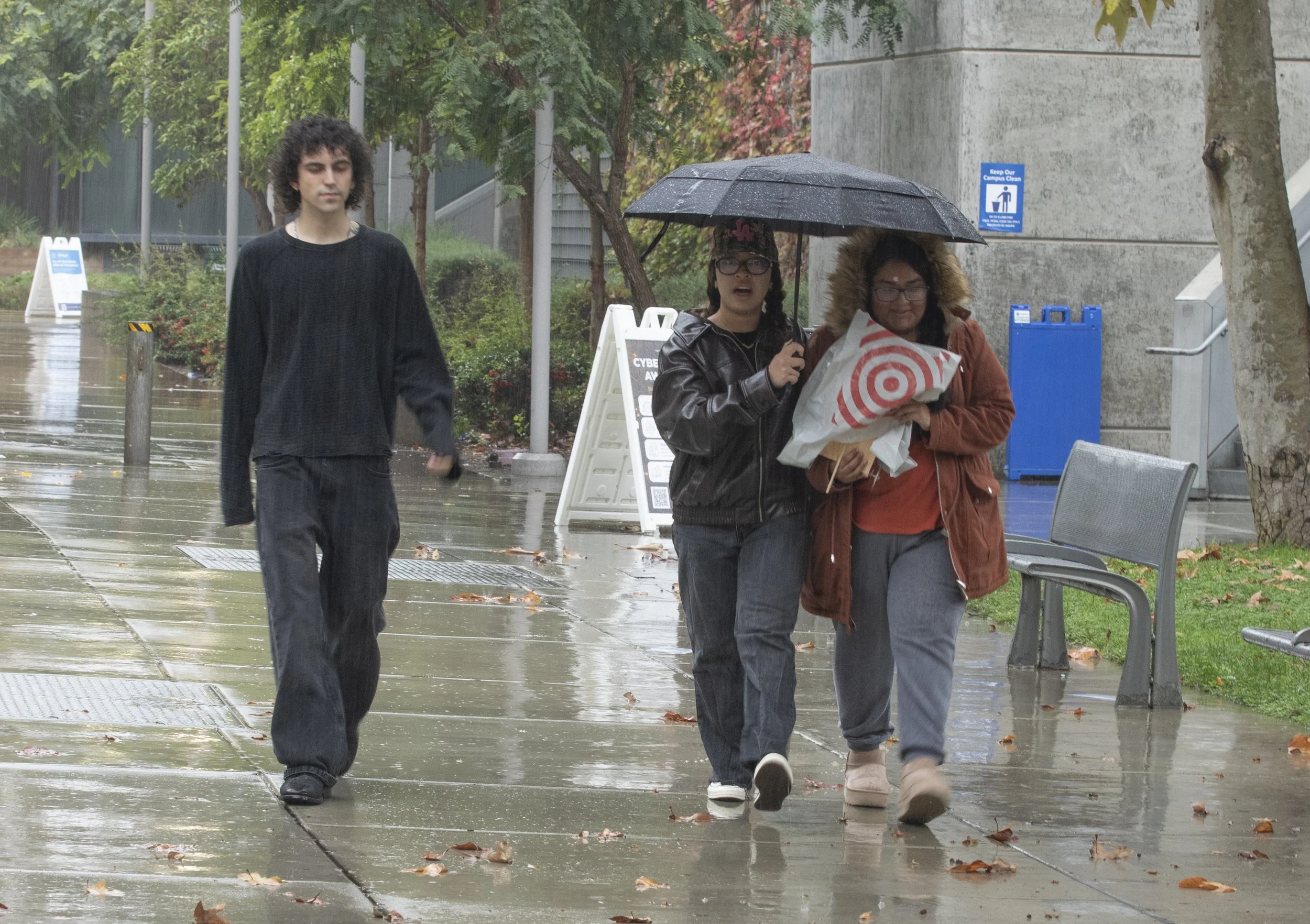  Santa Monica College (SMC) students walk in the rain on Friday, Nov. 14,  SMC, Santa Monica, Calif. Heavy rain fell through the weekend and another storm is expected to arrive on Thursday, Nov. 20.  (Fai Fong | The Corsair) 