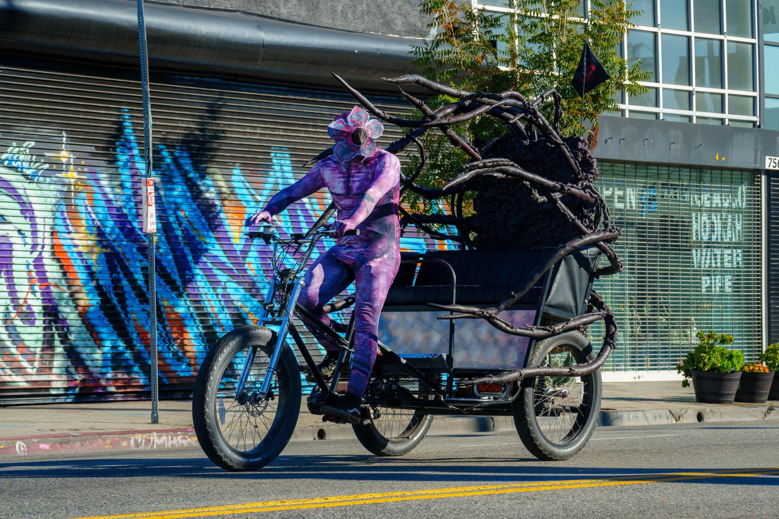  Armando Ramirez, dressed as the Demogorgon from the Netflix show Stranger Things, drives a stylized pedicab during Netflix x CicLAvia - Melrose Ave: Stranger Things 5 “One Last Ride” event on Sunday, Nov. 23, 2025, on a car-free section of Melrose A